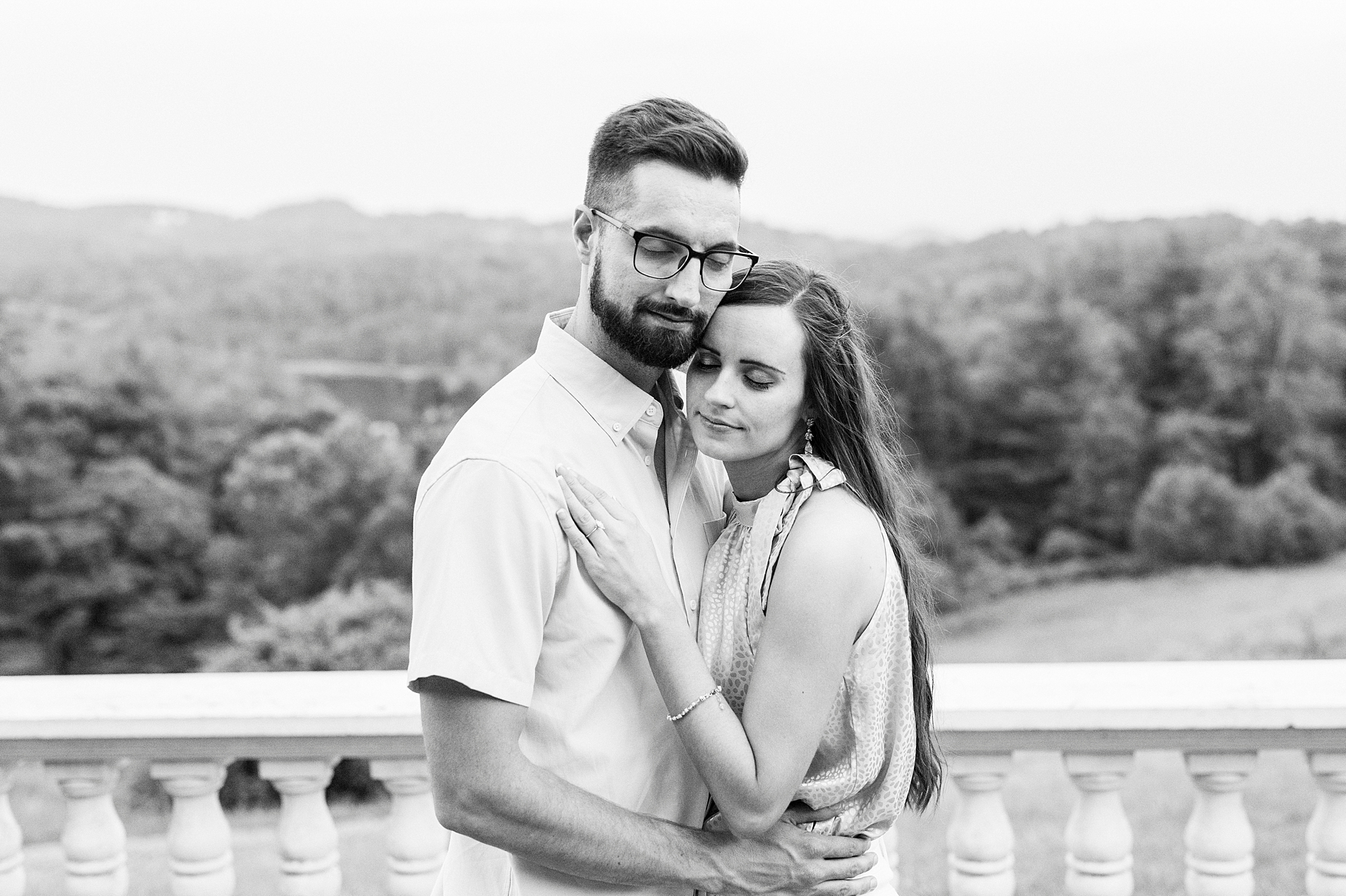 engaged couple hugs on patio during Blue Ridge Parkway engagement session