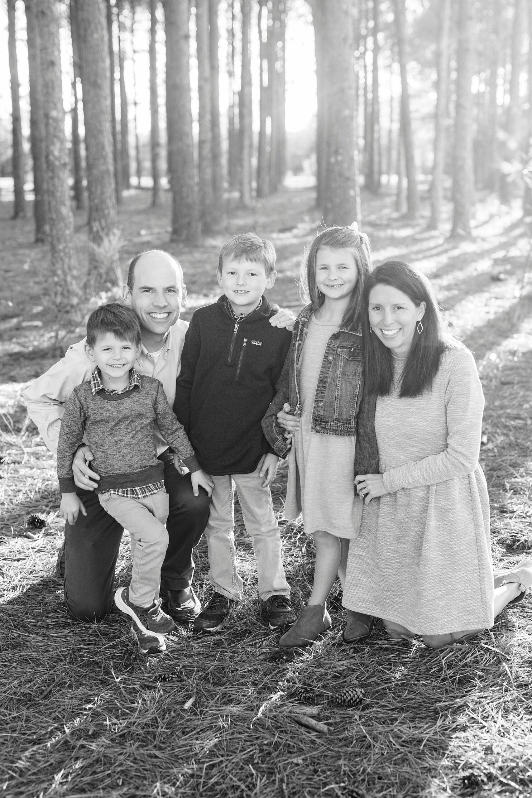 family stands together on edge of the woods at Frank Liske Park