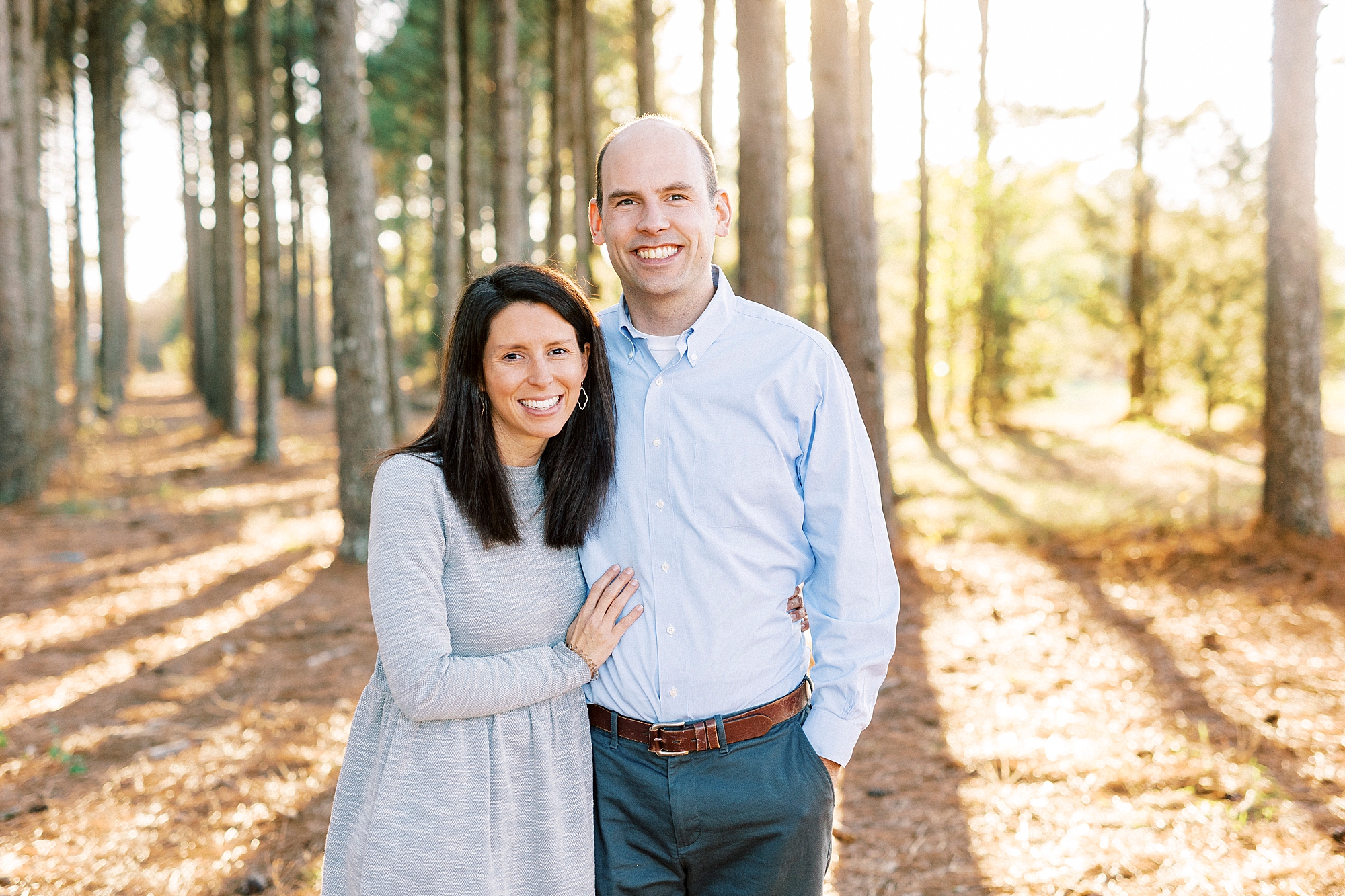 parents hug during fall family photos in Frank Liske Park