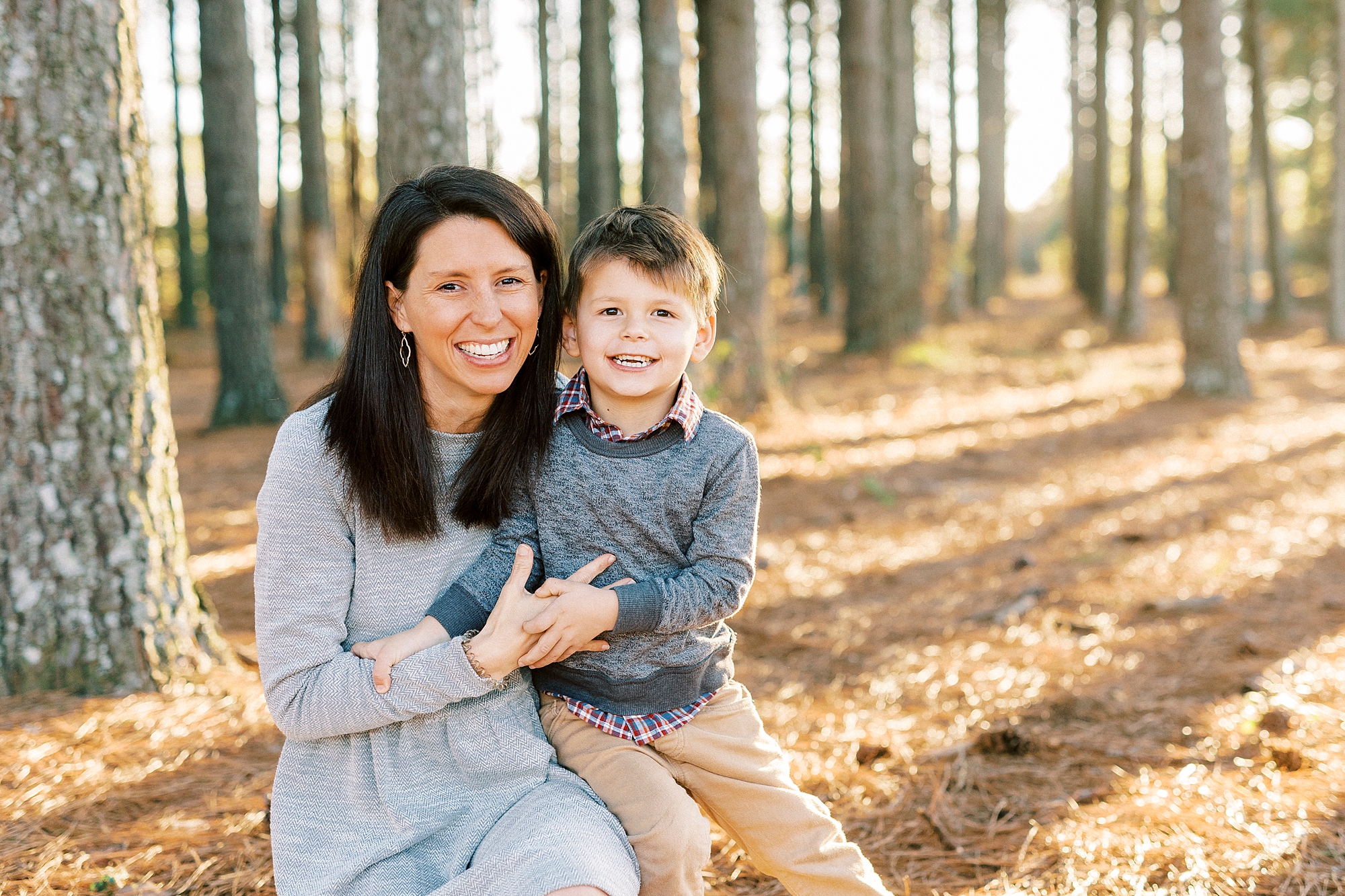 son sits on mom's lap during fall family photos at Frank Liske Park