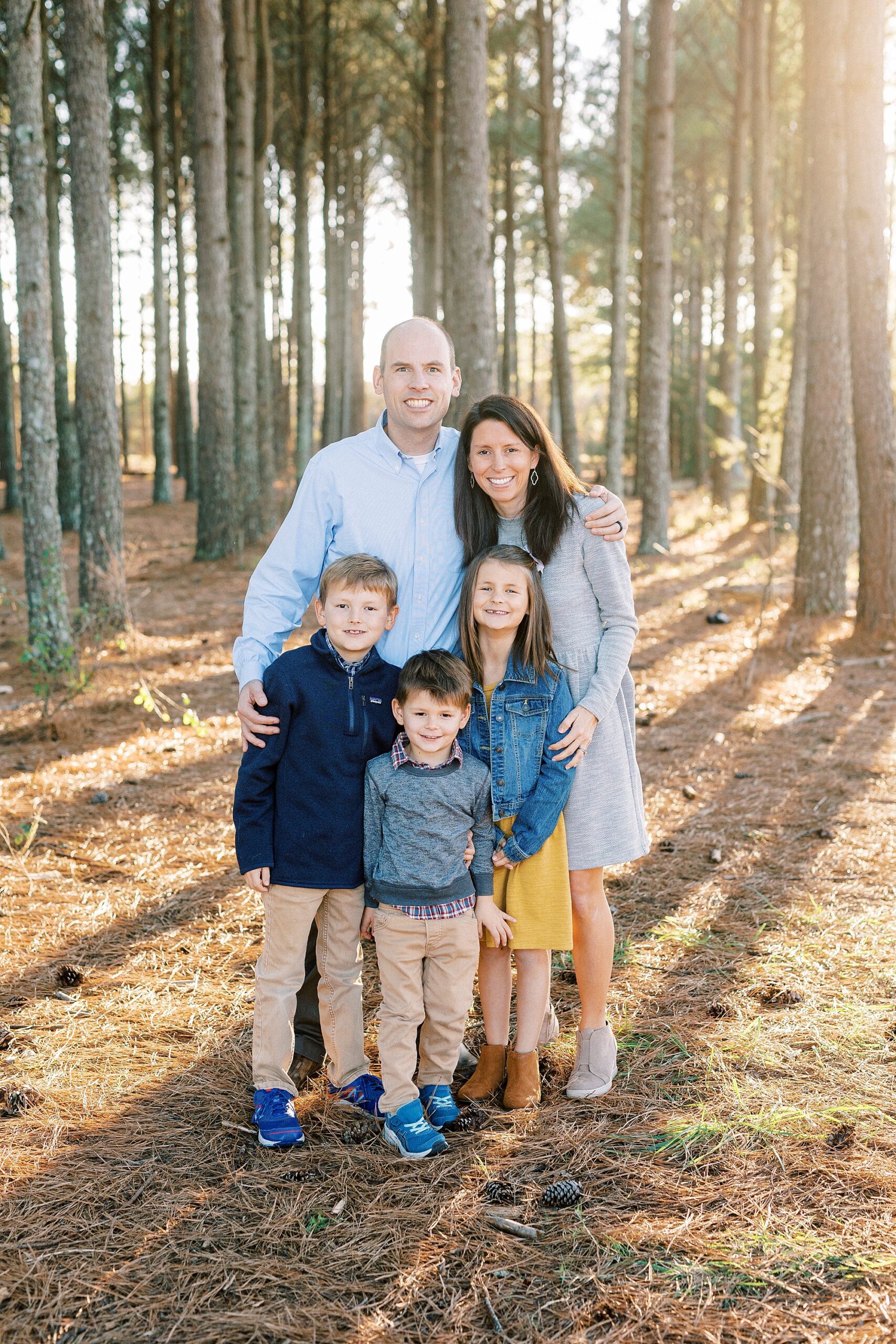 parents hug three kids during fall portraits at Frank Liske Park