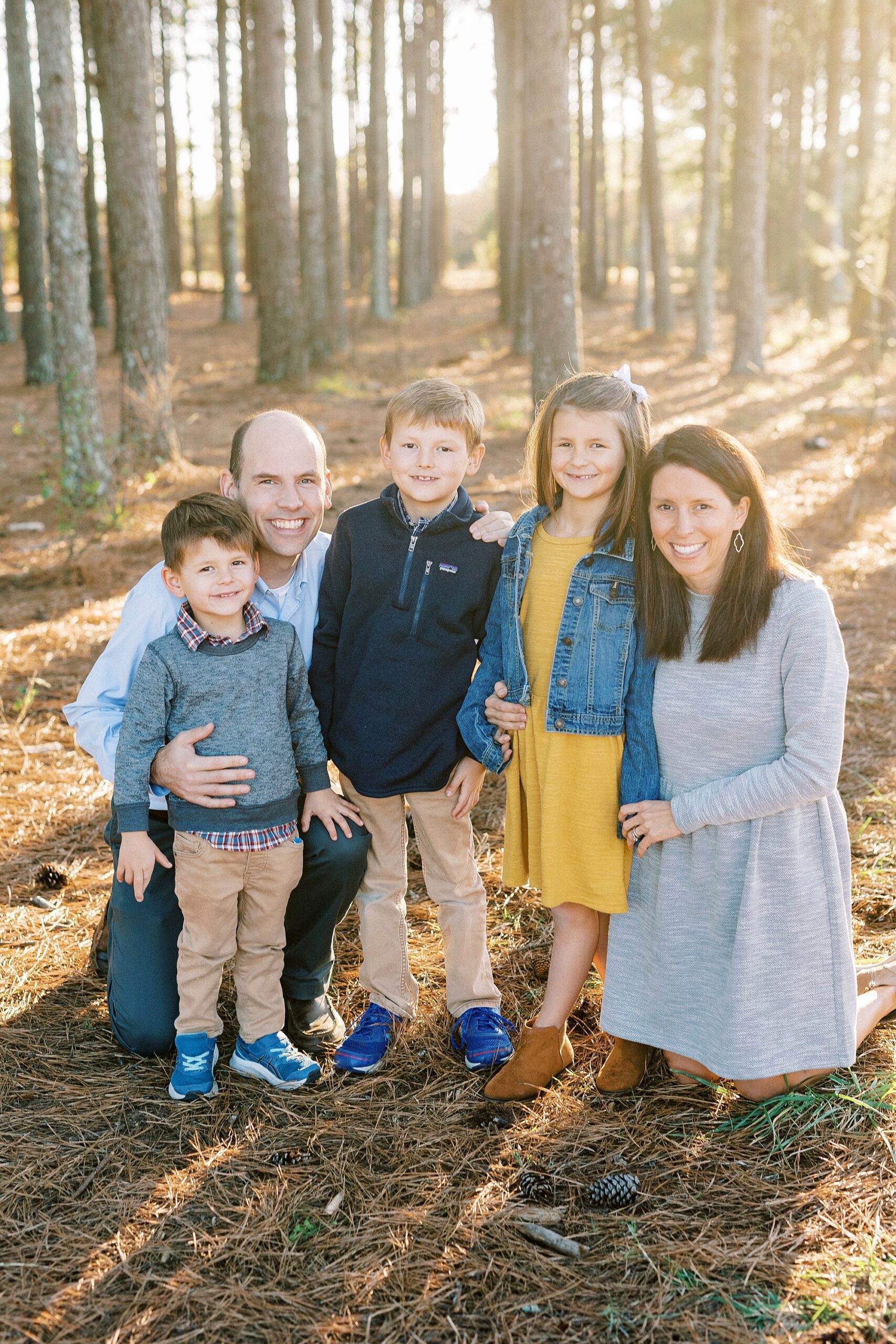 three kids stand with parents during Concord NC family photos