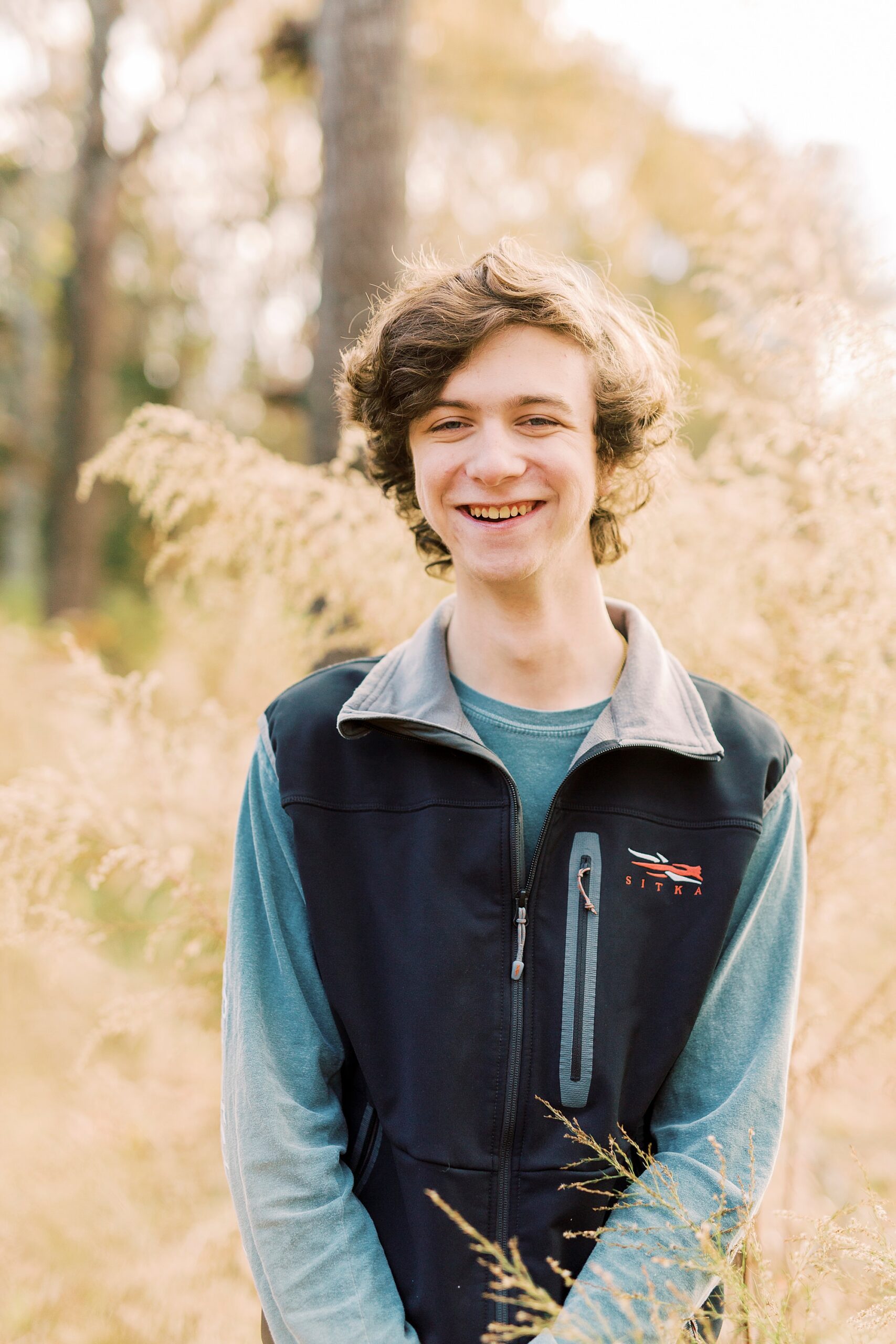 senior boy laughs during portraits in Midland NC