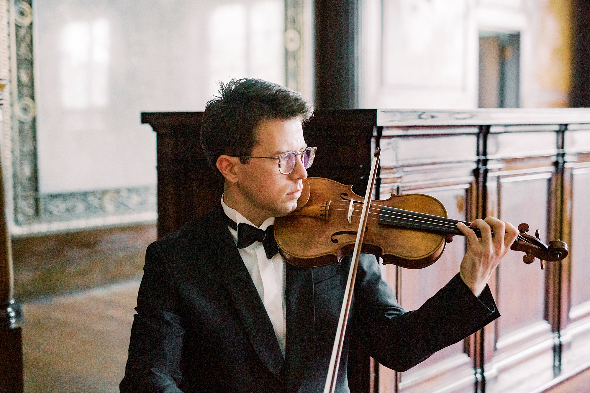 man plays violin during headshots in South Carolina