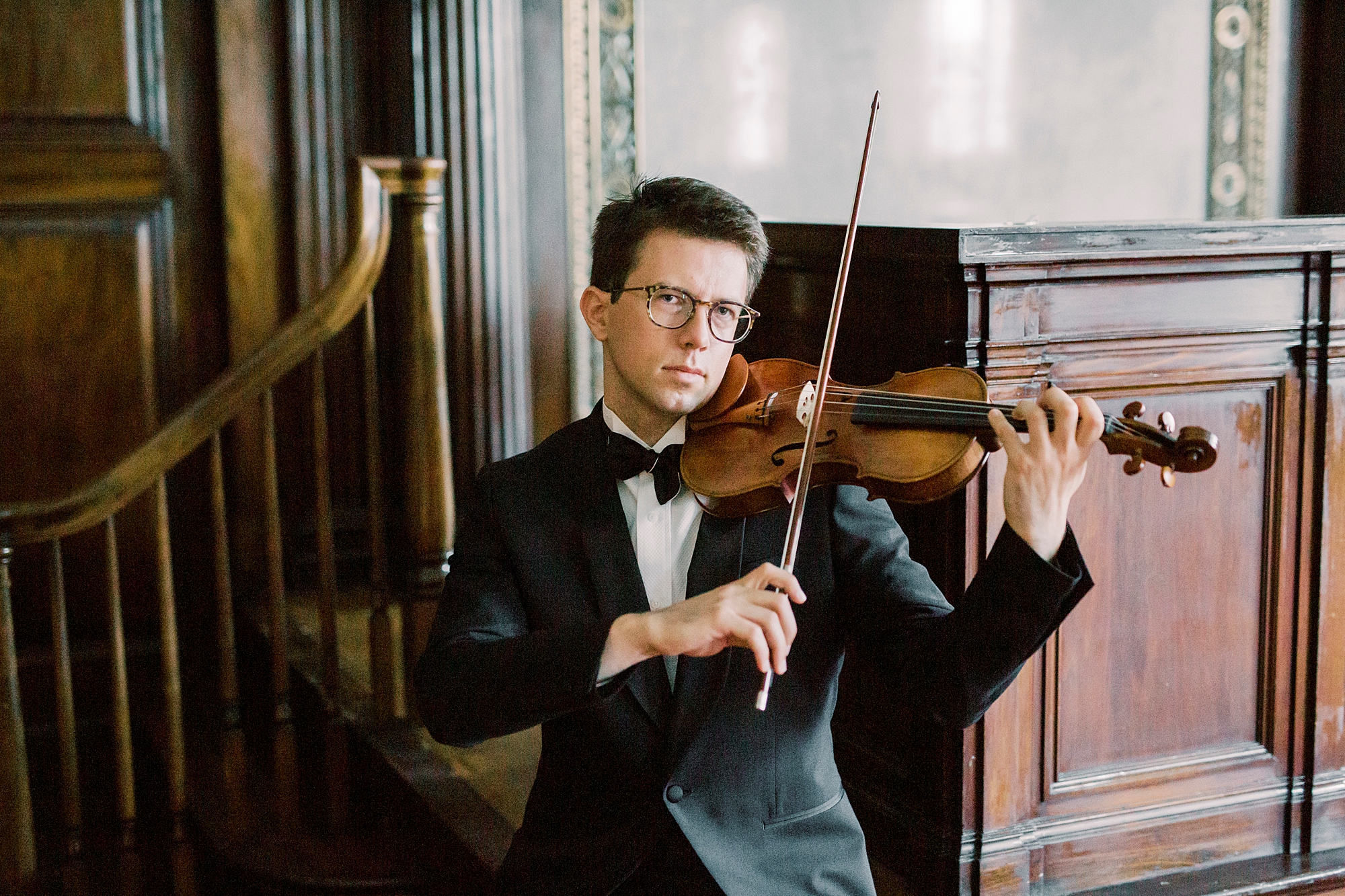 headshots for violin player holding violin under his chin