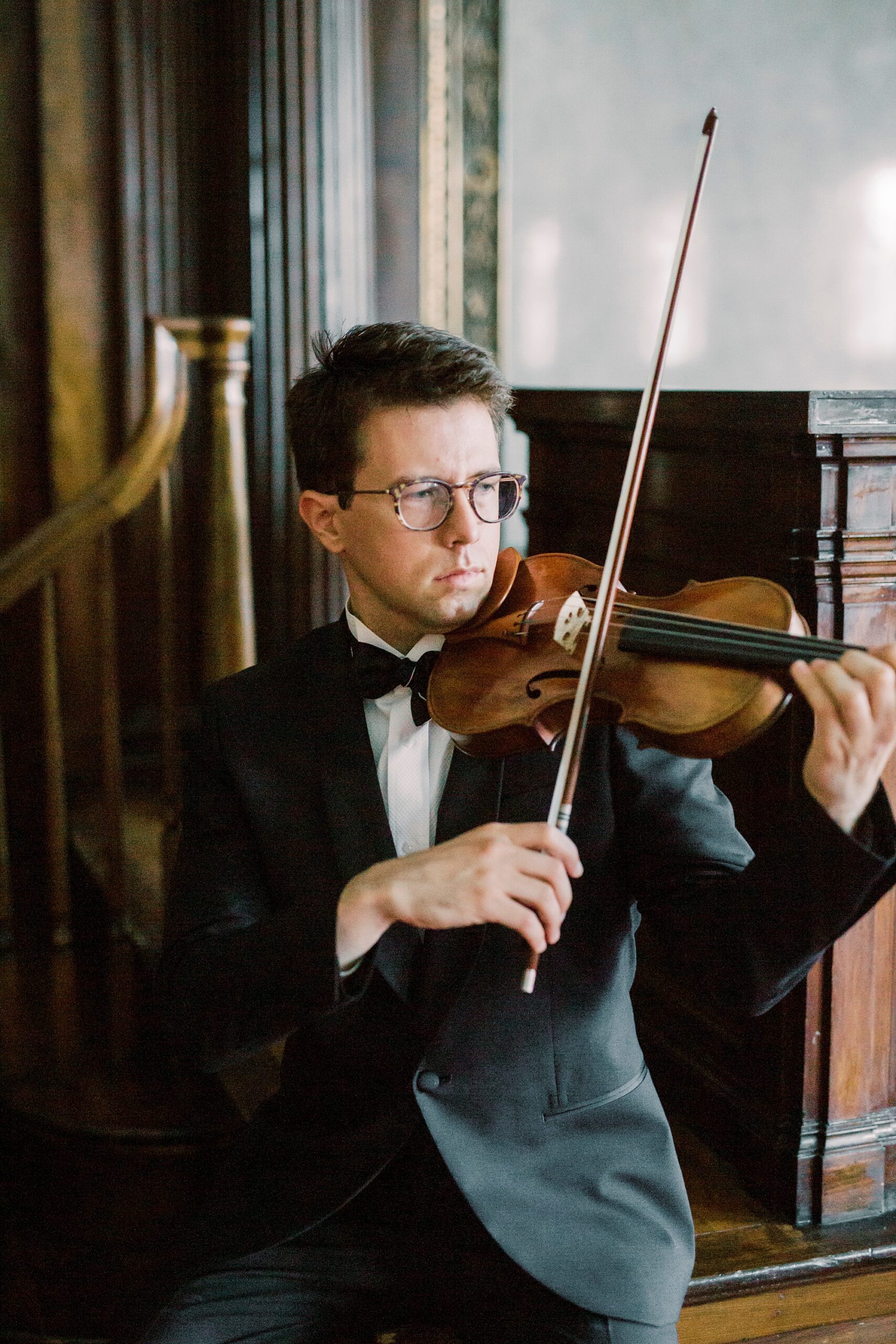 man plays violin in Rock Hill SC home