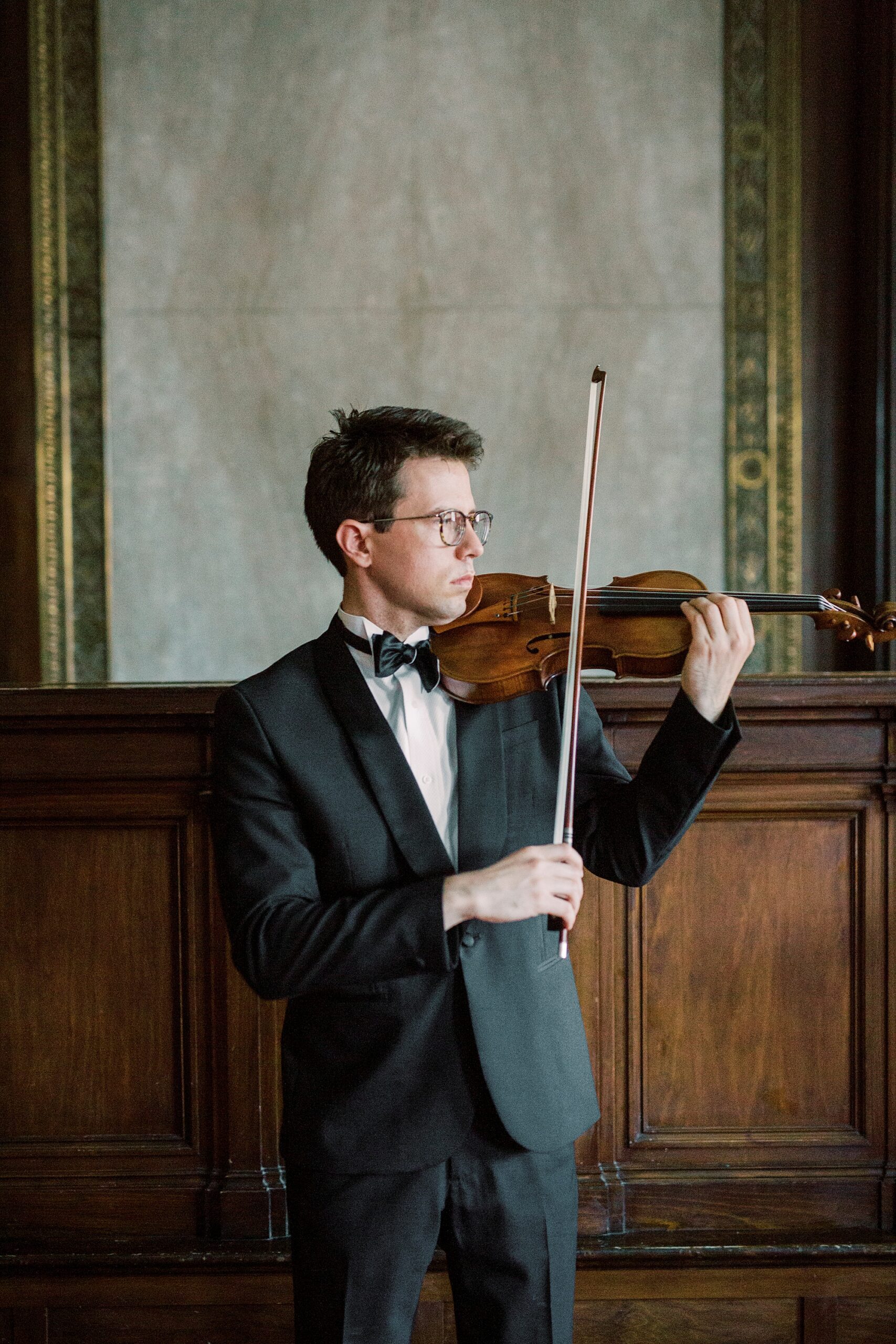 violin player plays in hallway of SC home