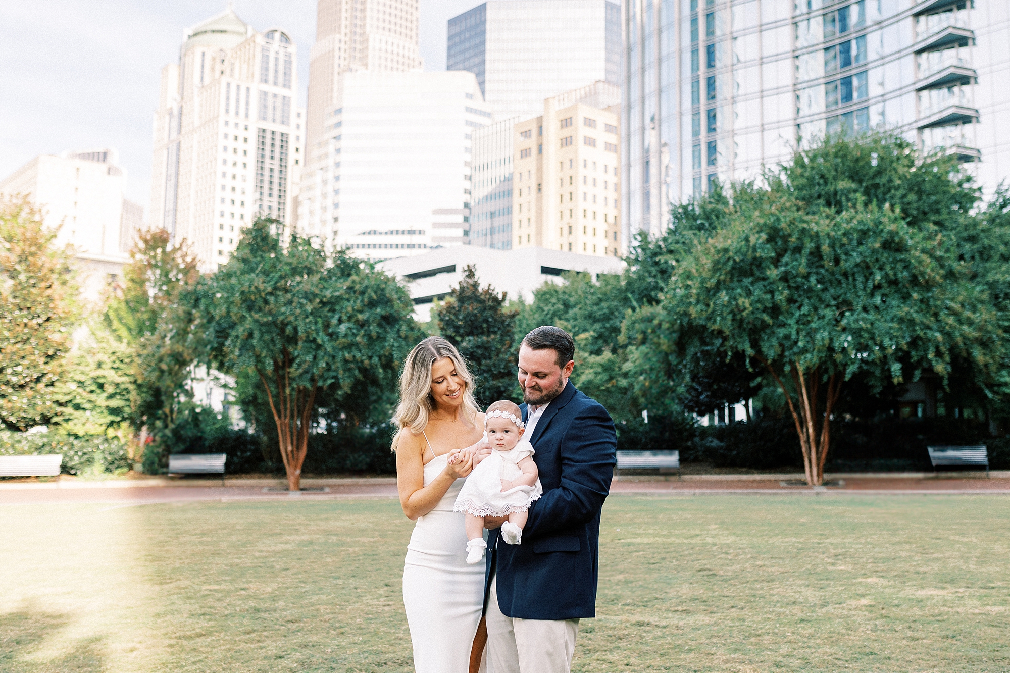parents look at daughter standing in Romare Bearden Park