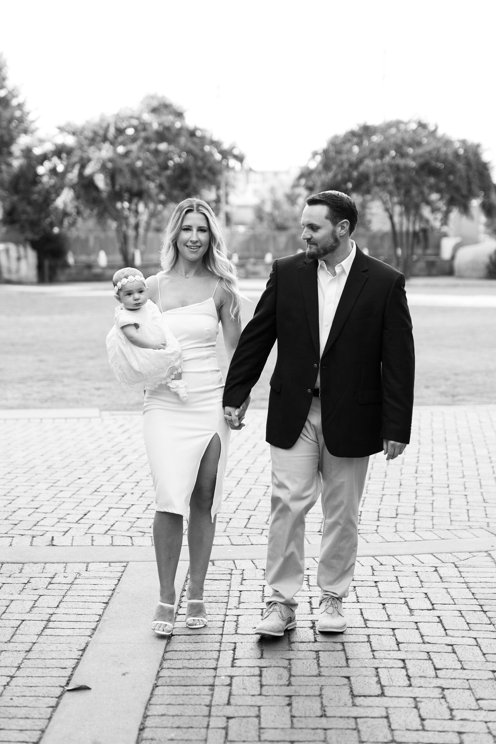 engaged couple holds hands walking through Romare Bearden Park