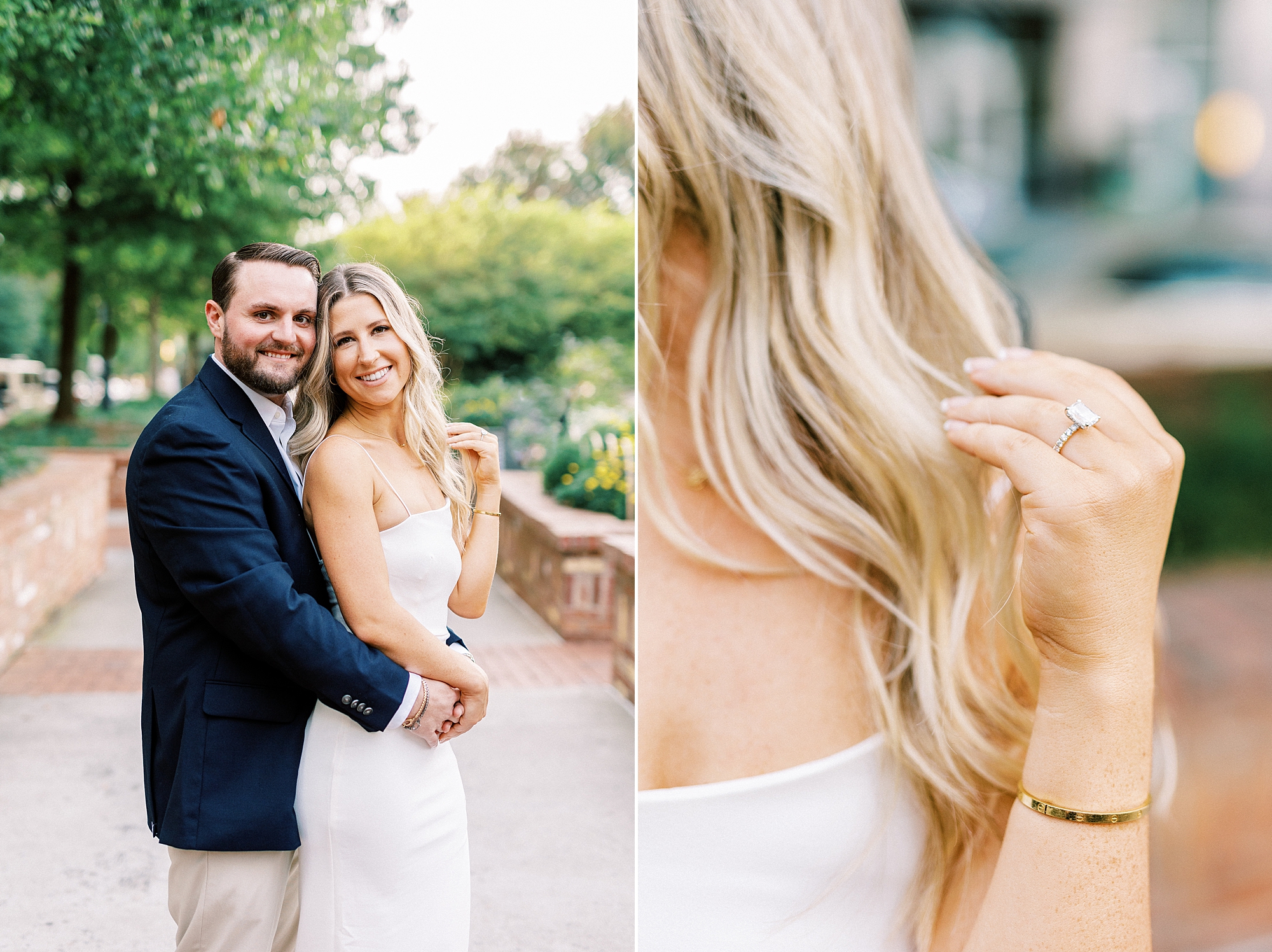 man in navy suit hugs woman in white dress while she twirls her hair