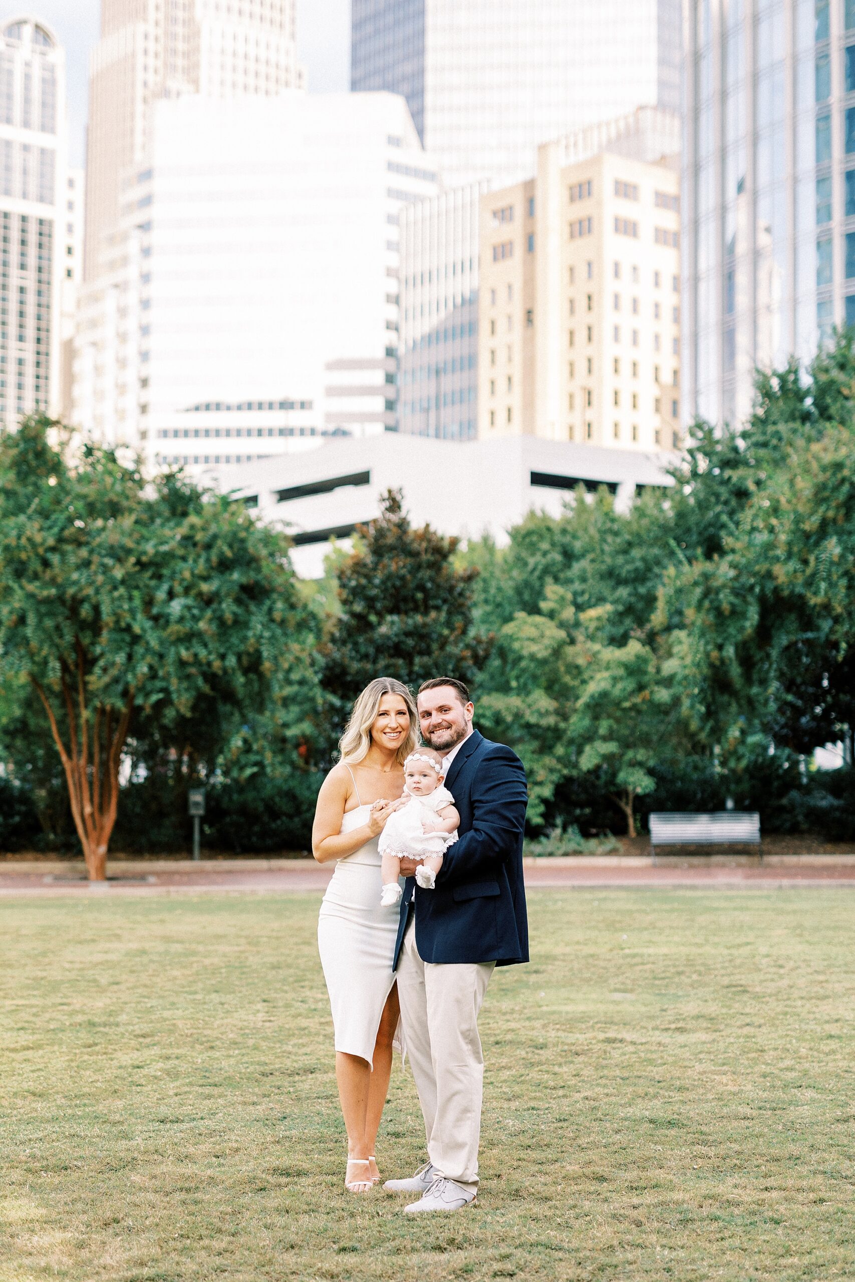 engaged couple hugs daughter in Romare Bearden Park