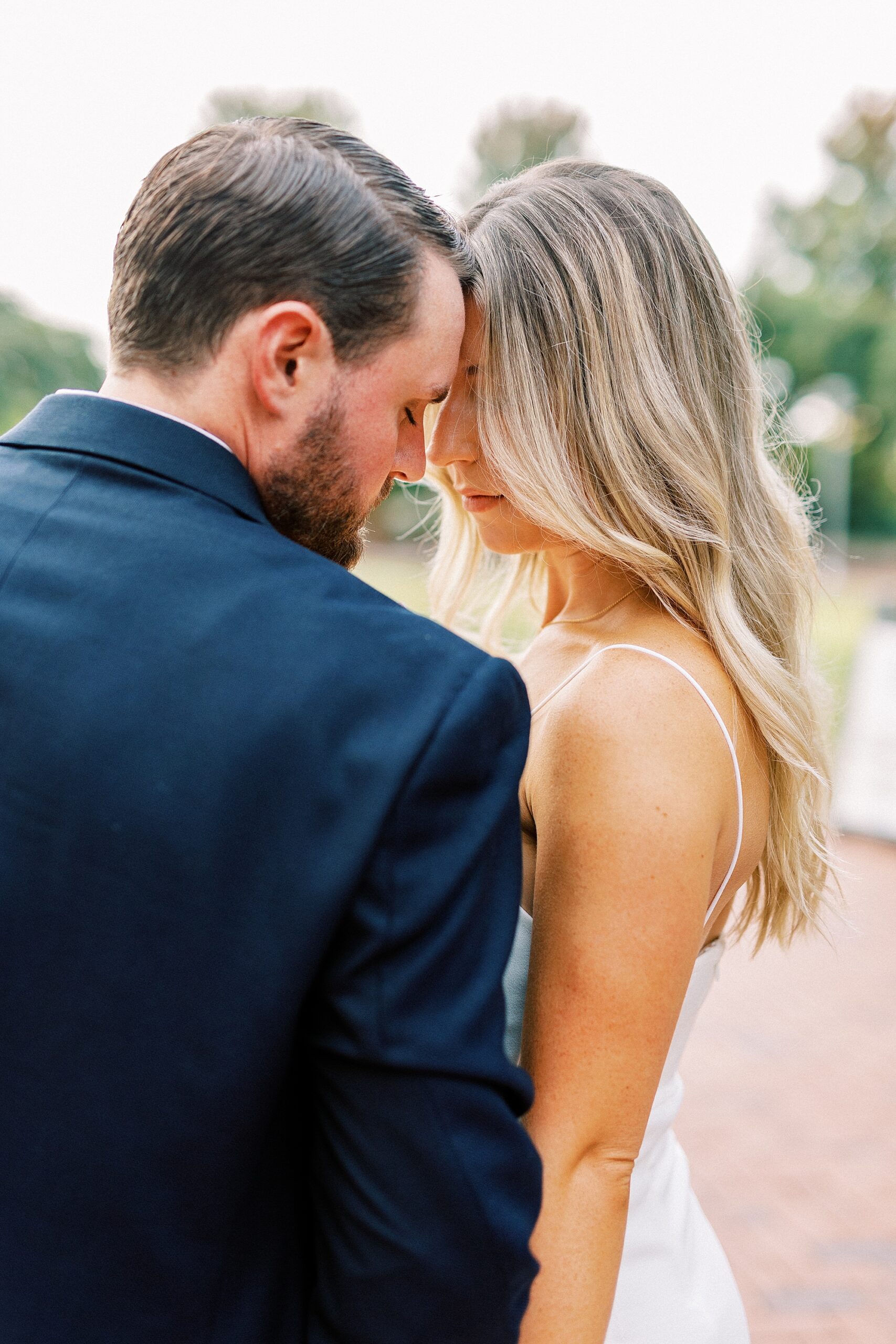 couple leans heads together during Romare Bearden Park engagement session
