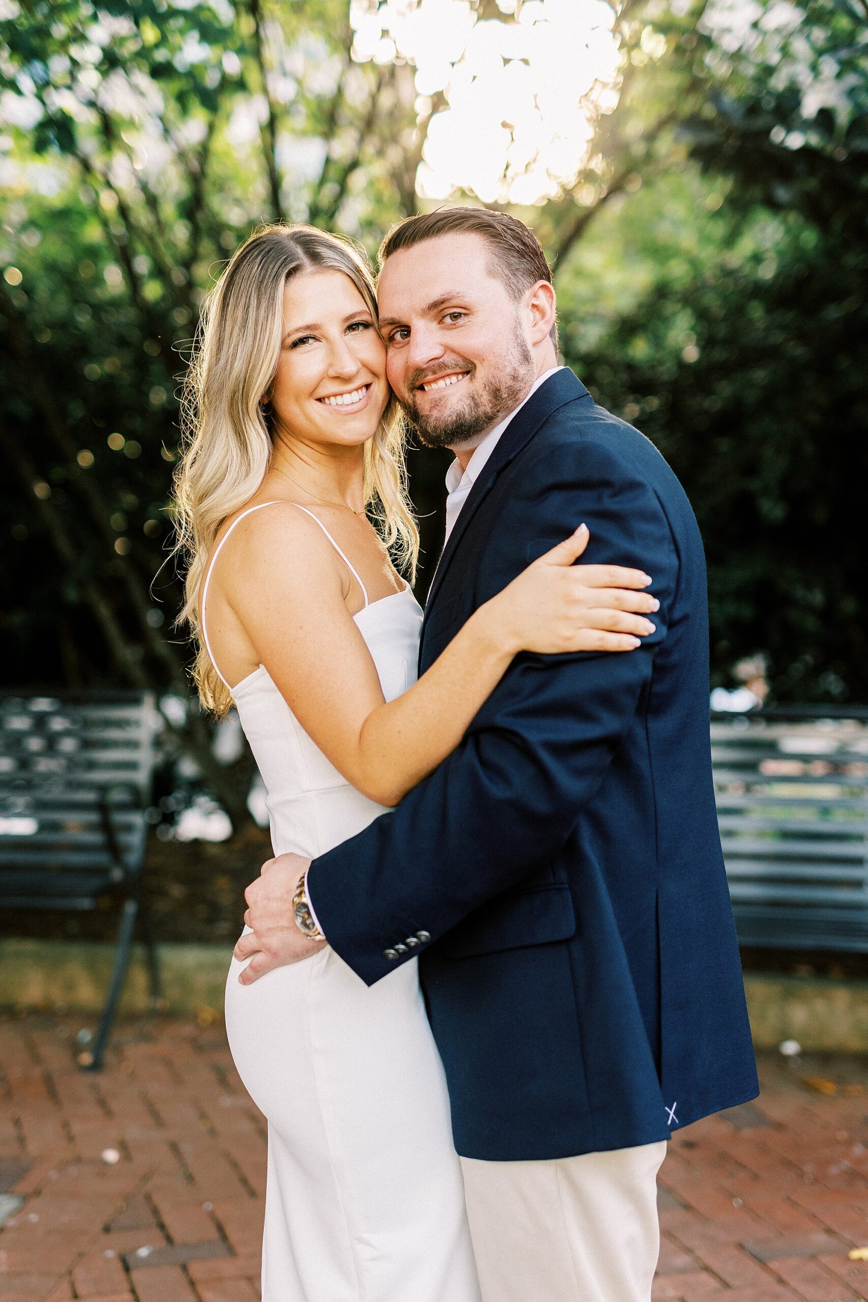 engaged couple hugs leaning heads together during Romare Bearden Park engagement session