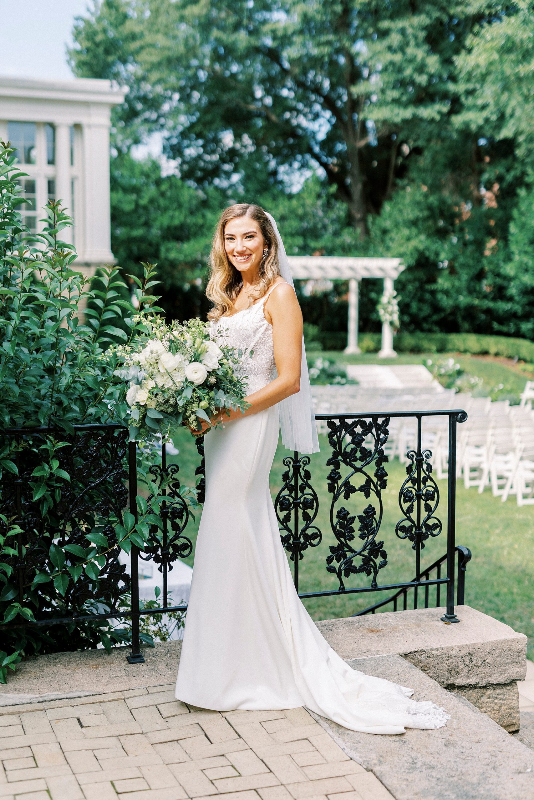 bride stands by patio with wrought iron railings at Separk Mansion