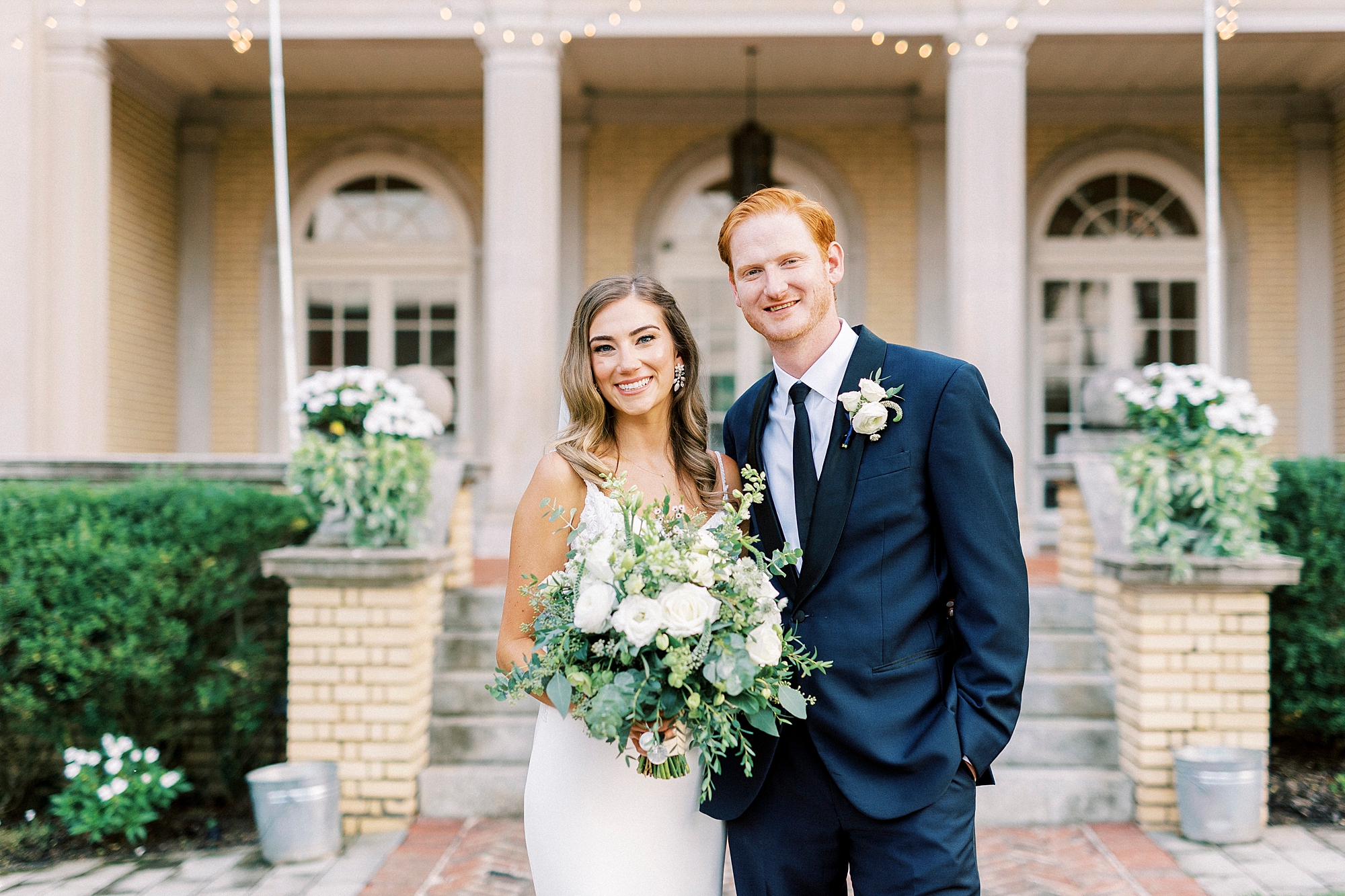 newlyweds stand hugging outside steps of Separk Mansion