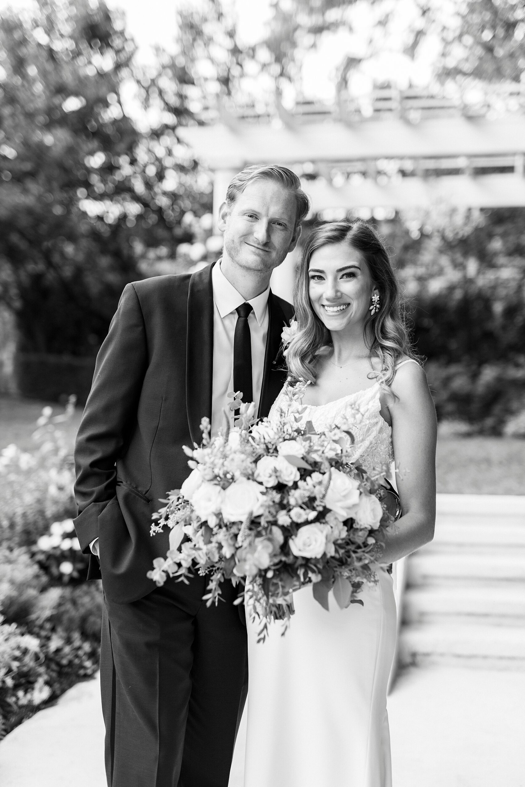 black and white photo of newlyweds hugging outside Separk Mansion