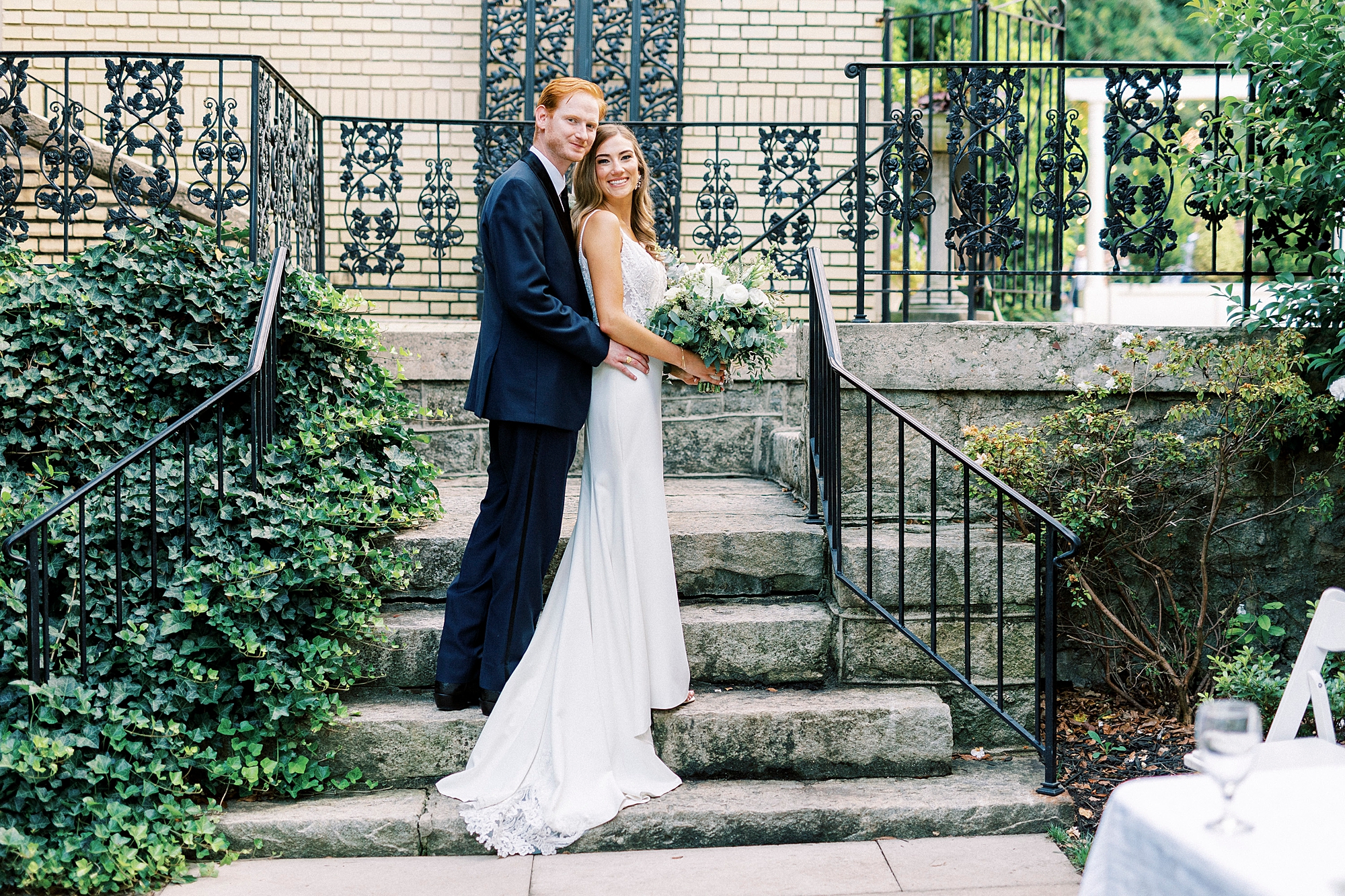 bride and groom hug on steps outside Separk Mansion
