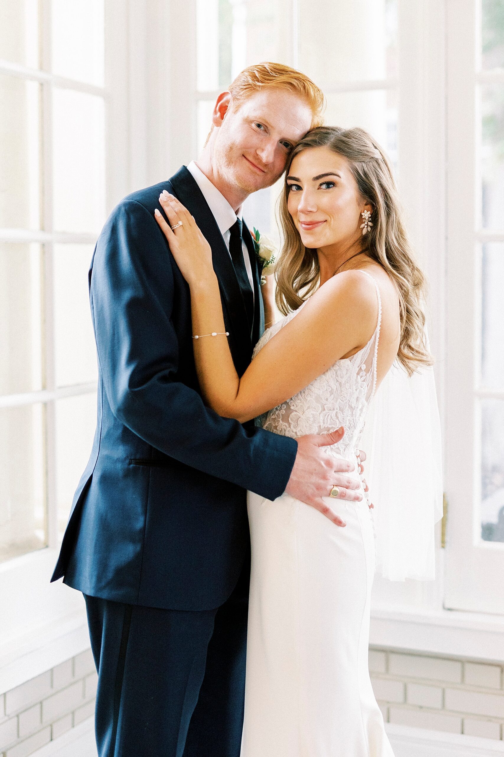 newlyweds hug leaning heads together inside Separk Mansion