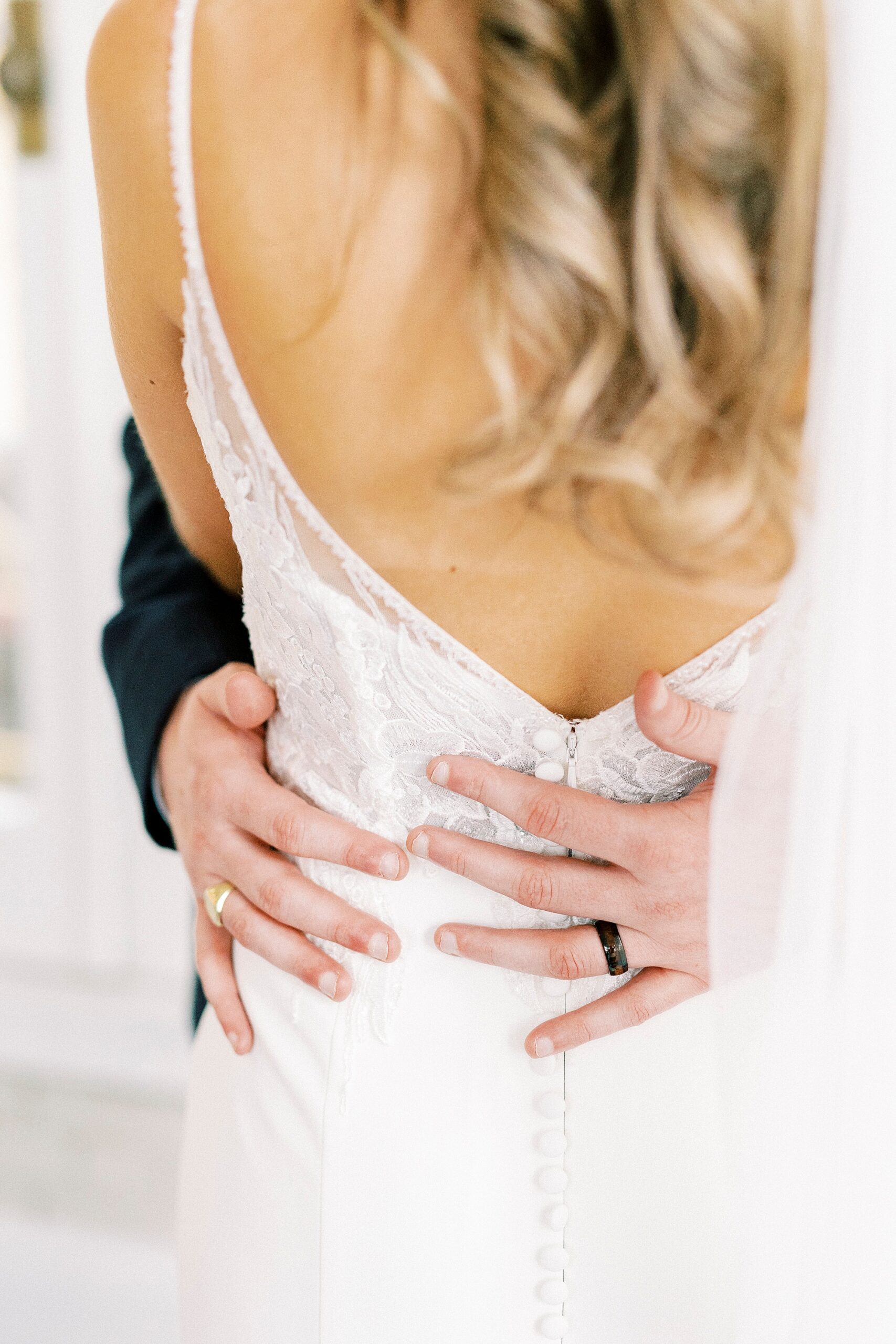groom hugs bride showing off wedding ring at Separk Mansion