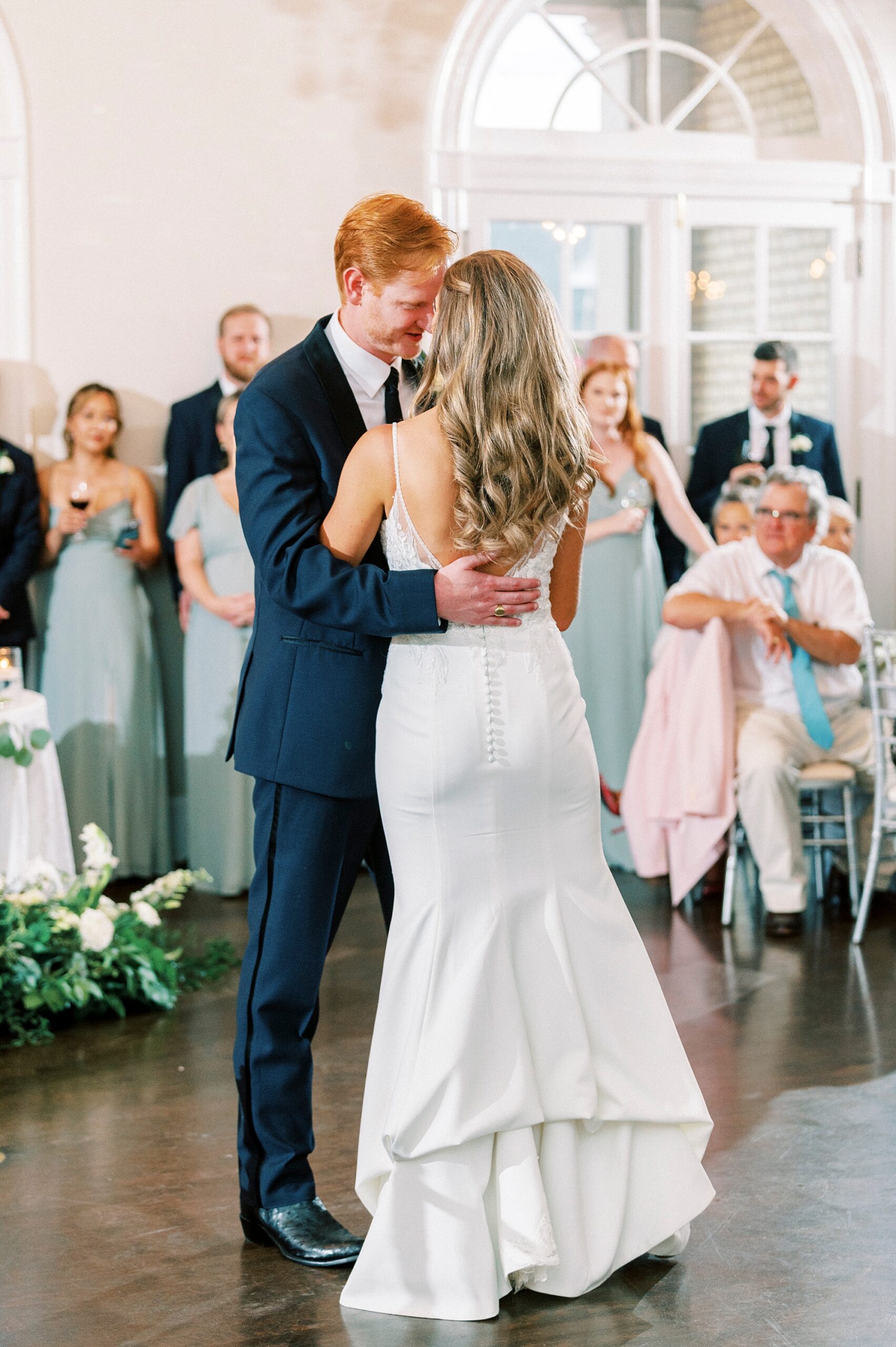 bride and groom dance with guests around them inside Separk Mansion