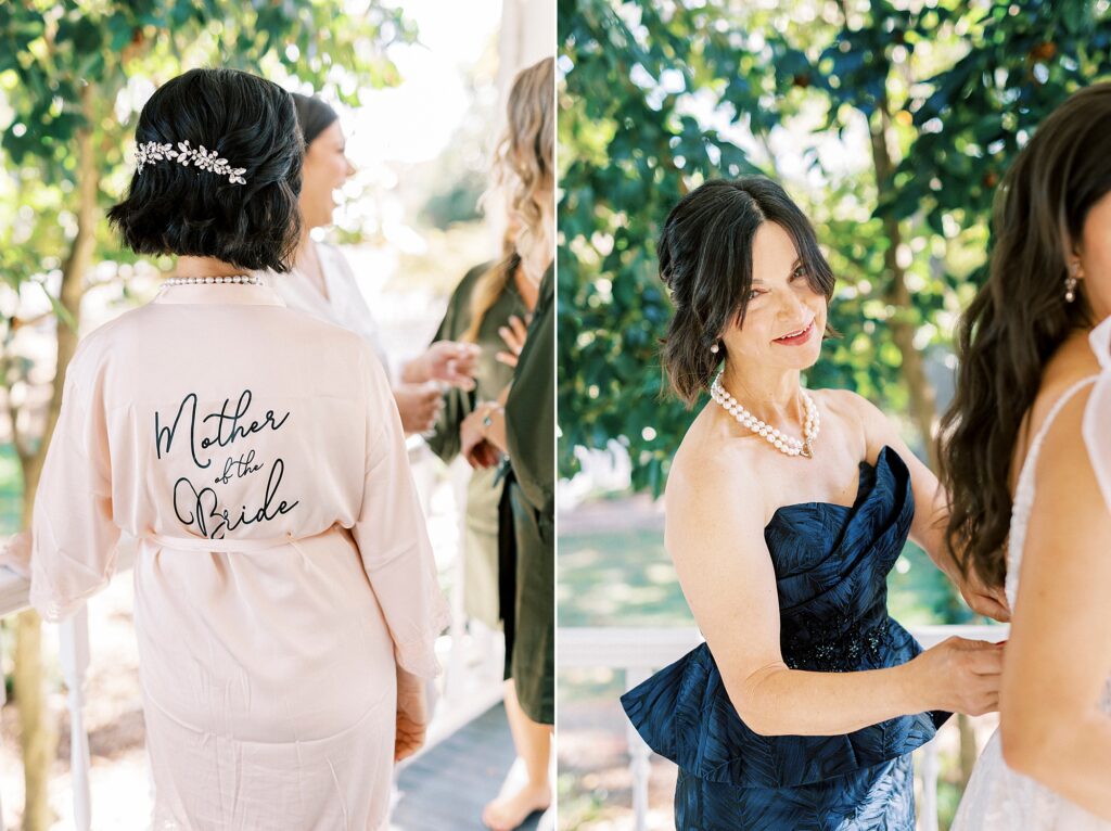 mother helps bride into wedding dress with pink robe