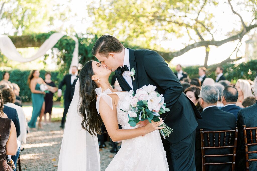 newlyweds kiss dipping together at ceremony in Charlotte NC
