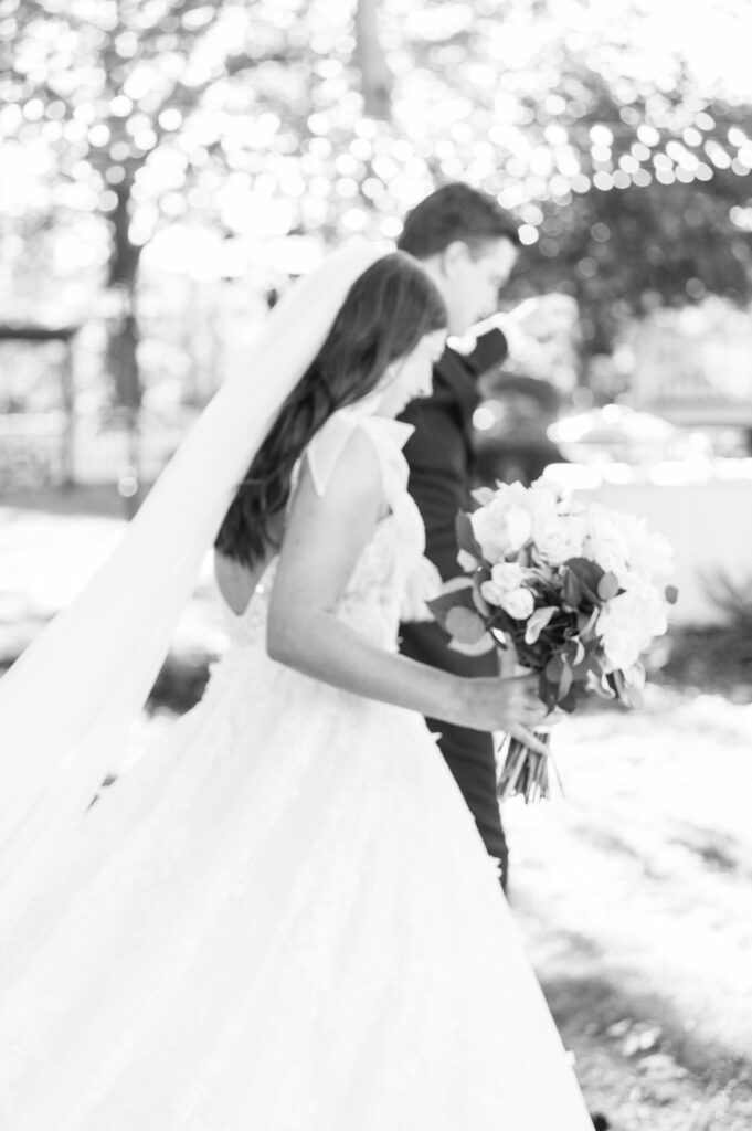 bride and groom walk away from ceremony smiling at Whitehead Manor