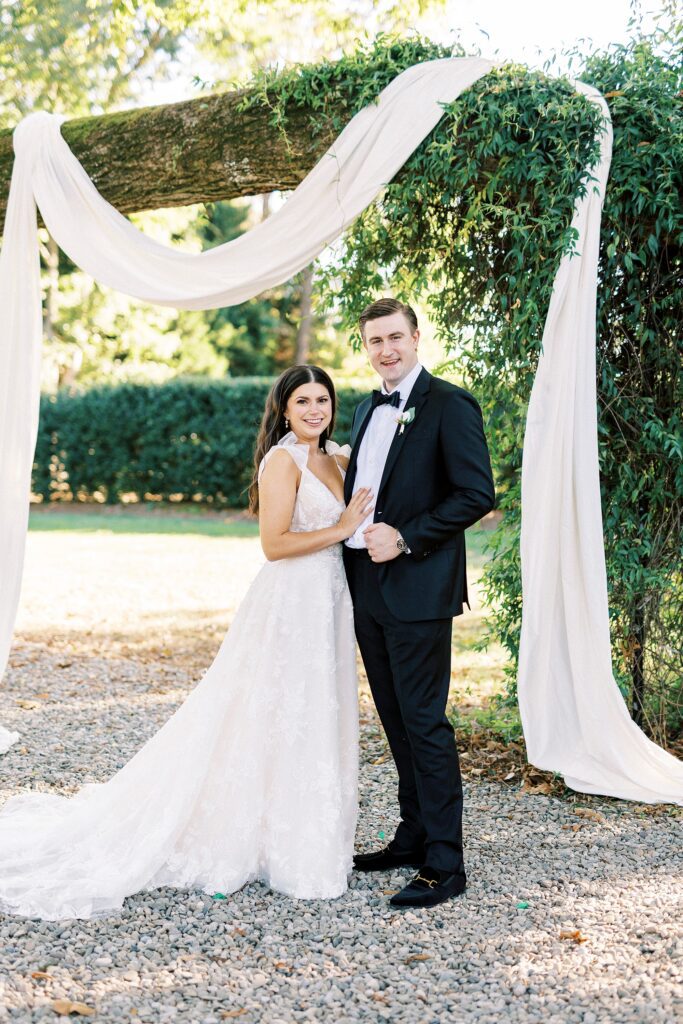bride and groom hug under arbor at Whitehead Manor