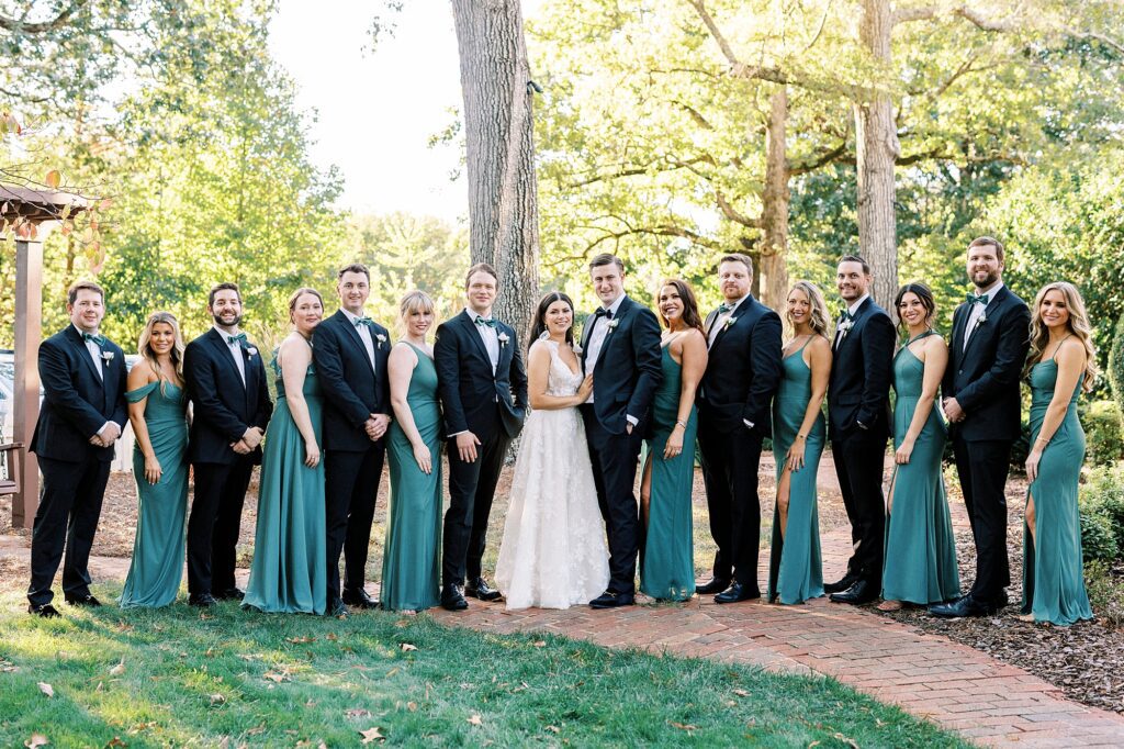 bride and groom pose together with wedding party at Whitehead Manor