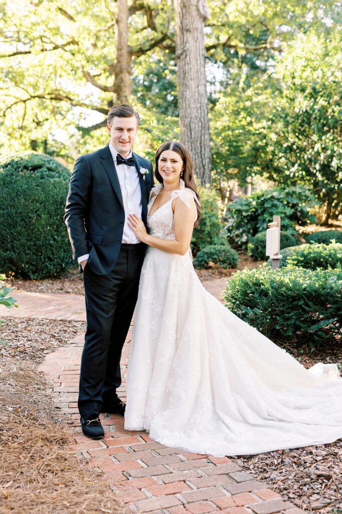 newlyweds hug on lawn at Whitehead Manor