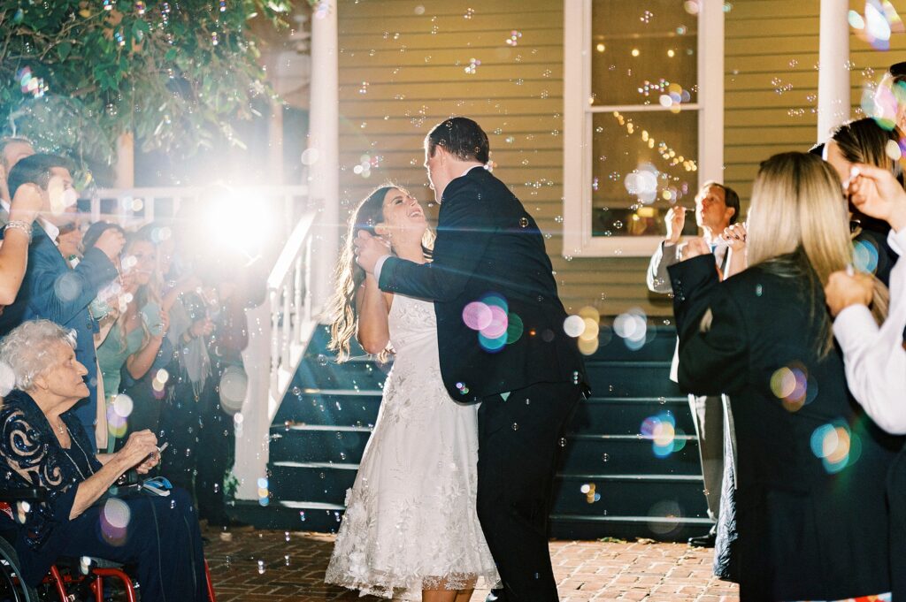 newlyweds dance during exit from wedding reception at Whitehead Manor
