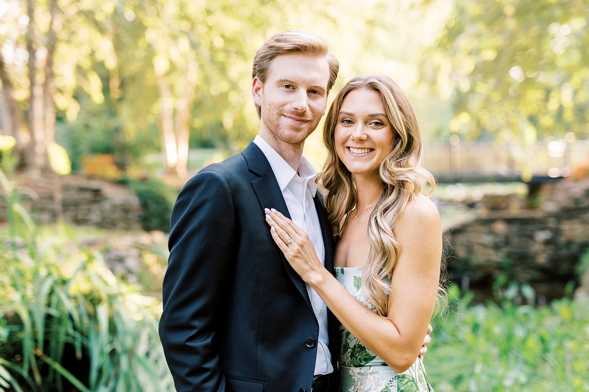 woman lays hand on groom's chest during garden engagement session in Rock Hill SC