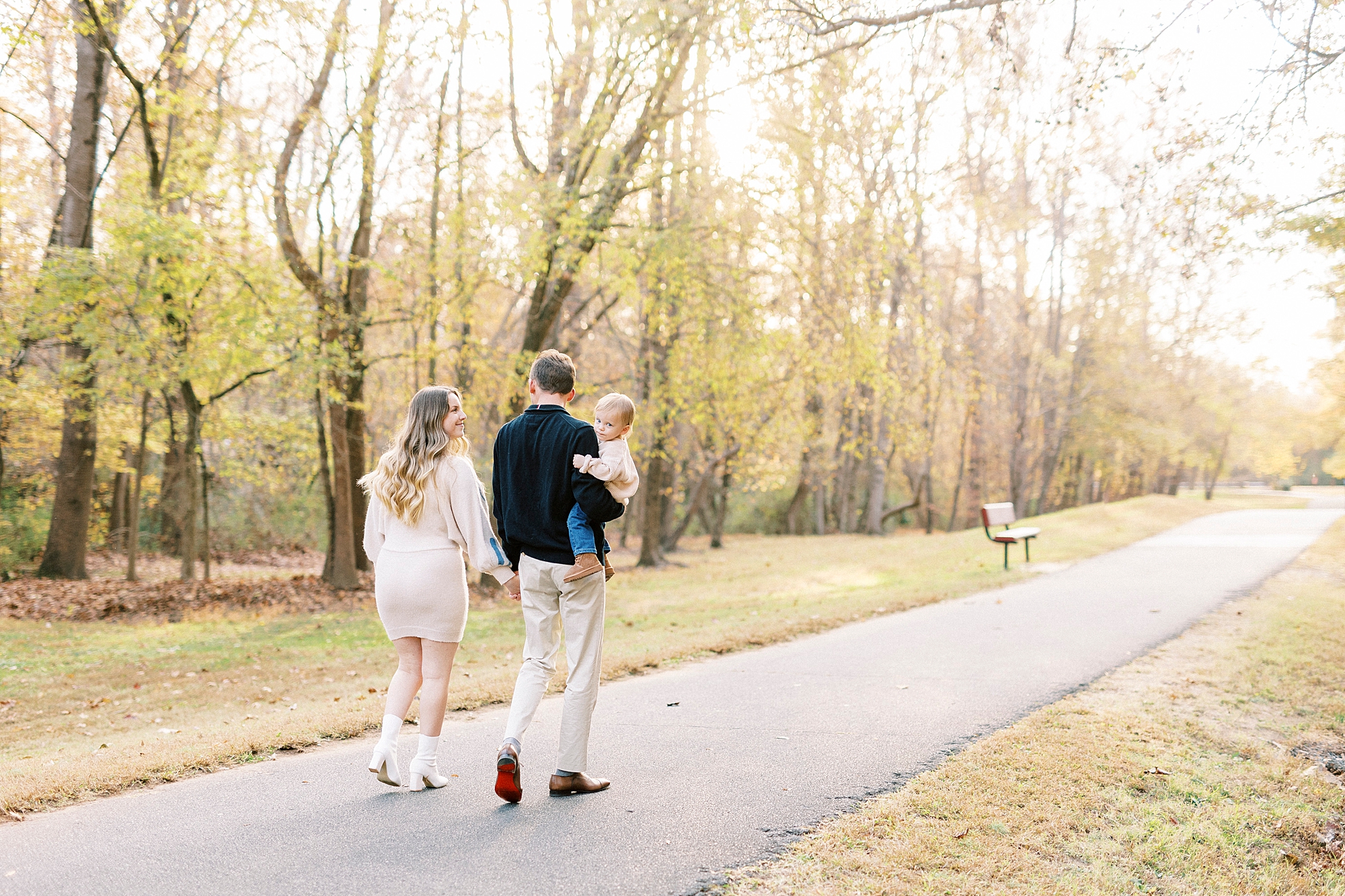 family of three walks down path at Baker's Creek Park