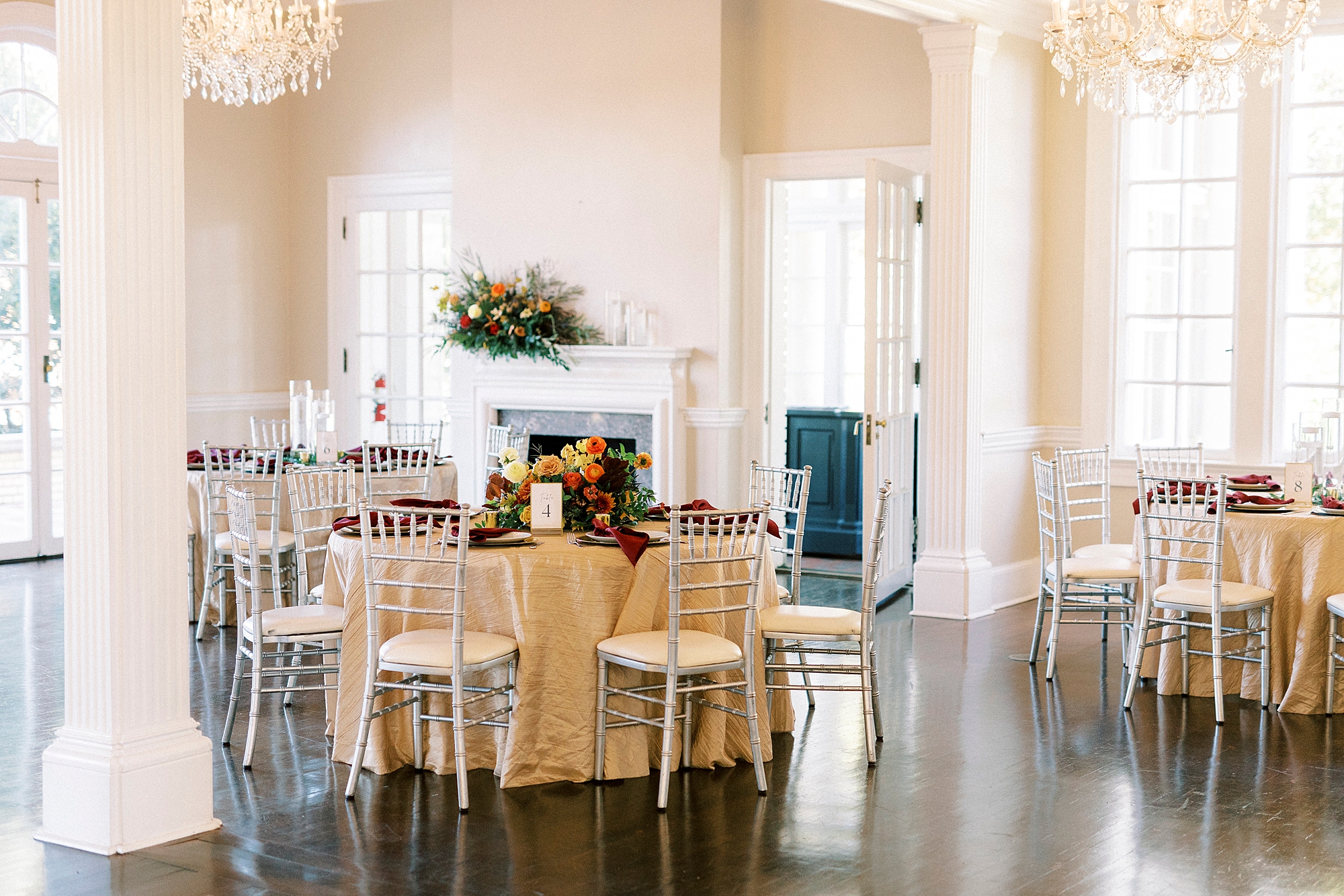 fall wedding reception at Separk Mansion with burgundy napkins and fall flower centerpieces