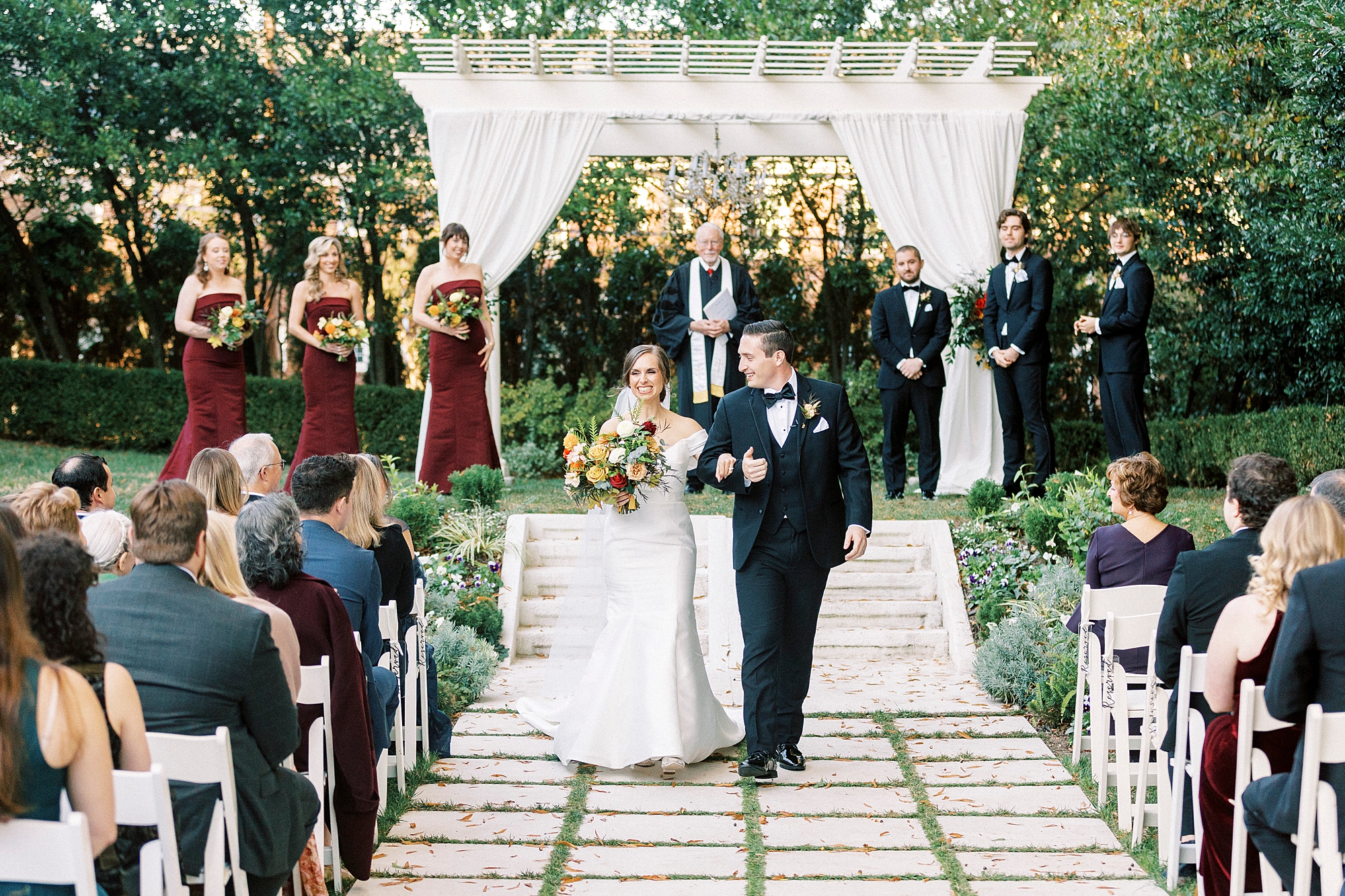 bride and groom walk away from gazebo during outdoor ceremony at Separk Mansion