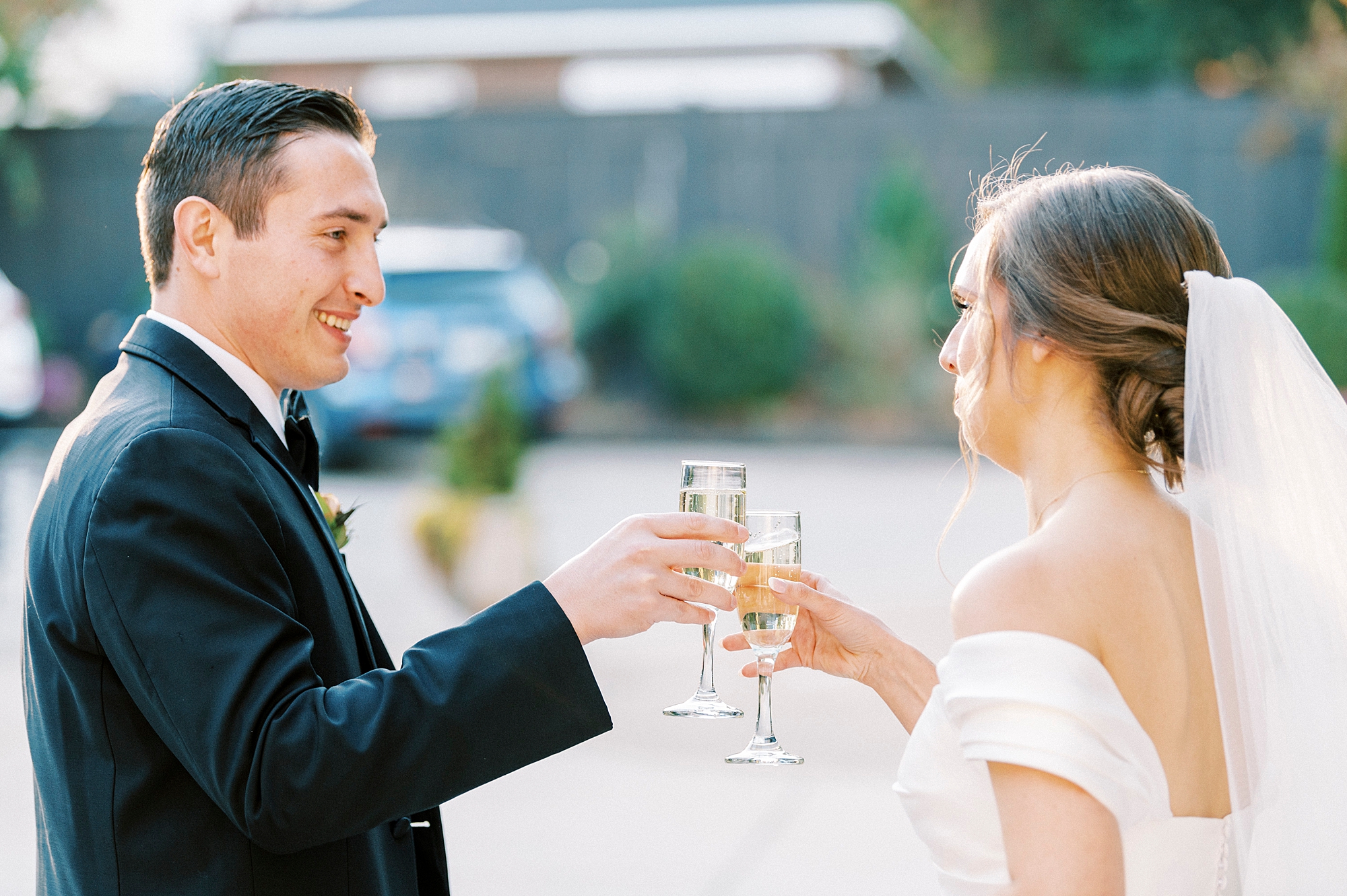 bride and groom toast champagne glasses during fall wedding day at Separk Mansion