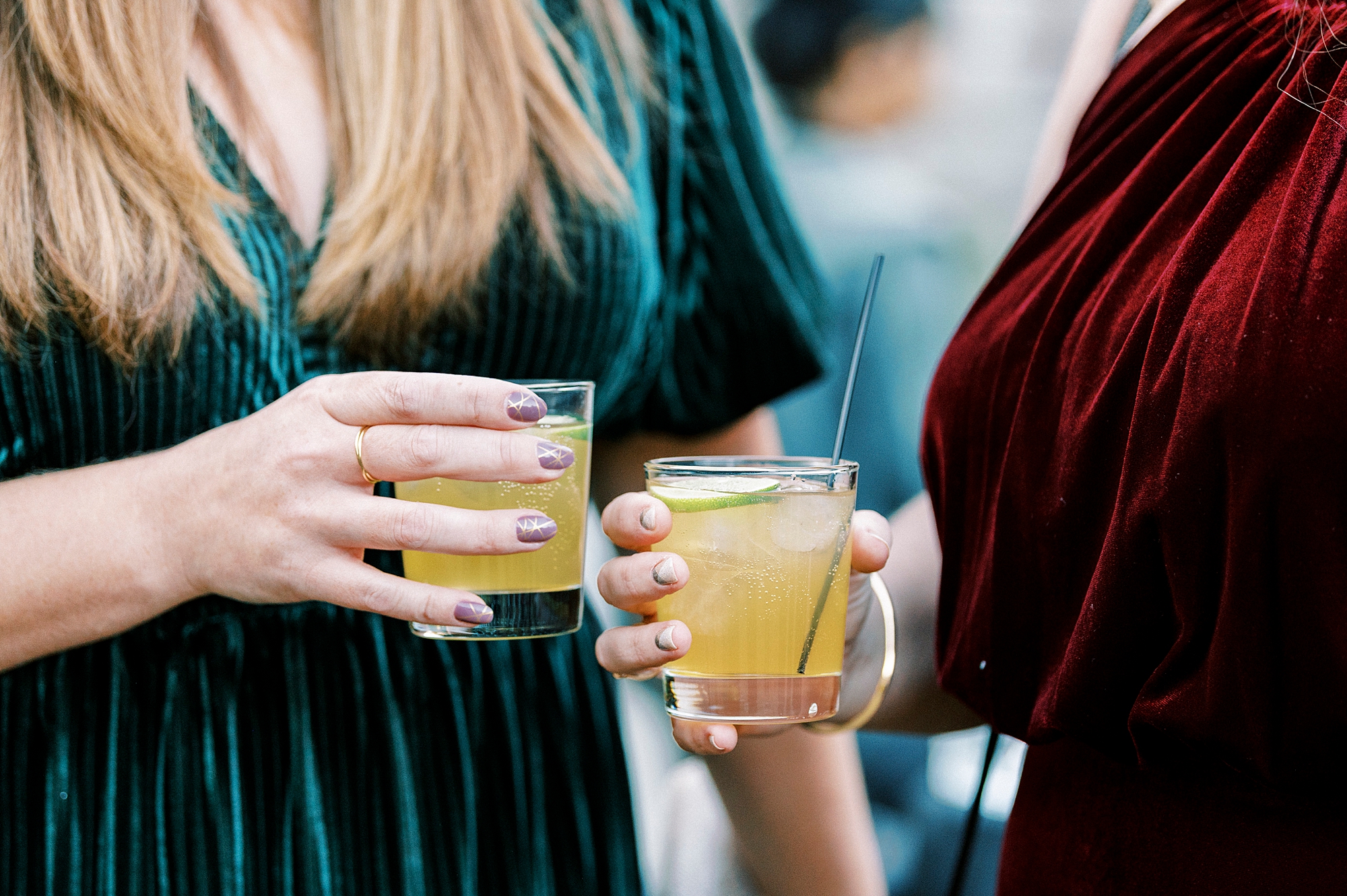 guests hold custom cocktails during fall wedding day