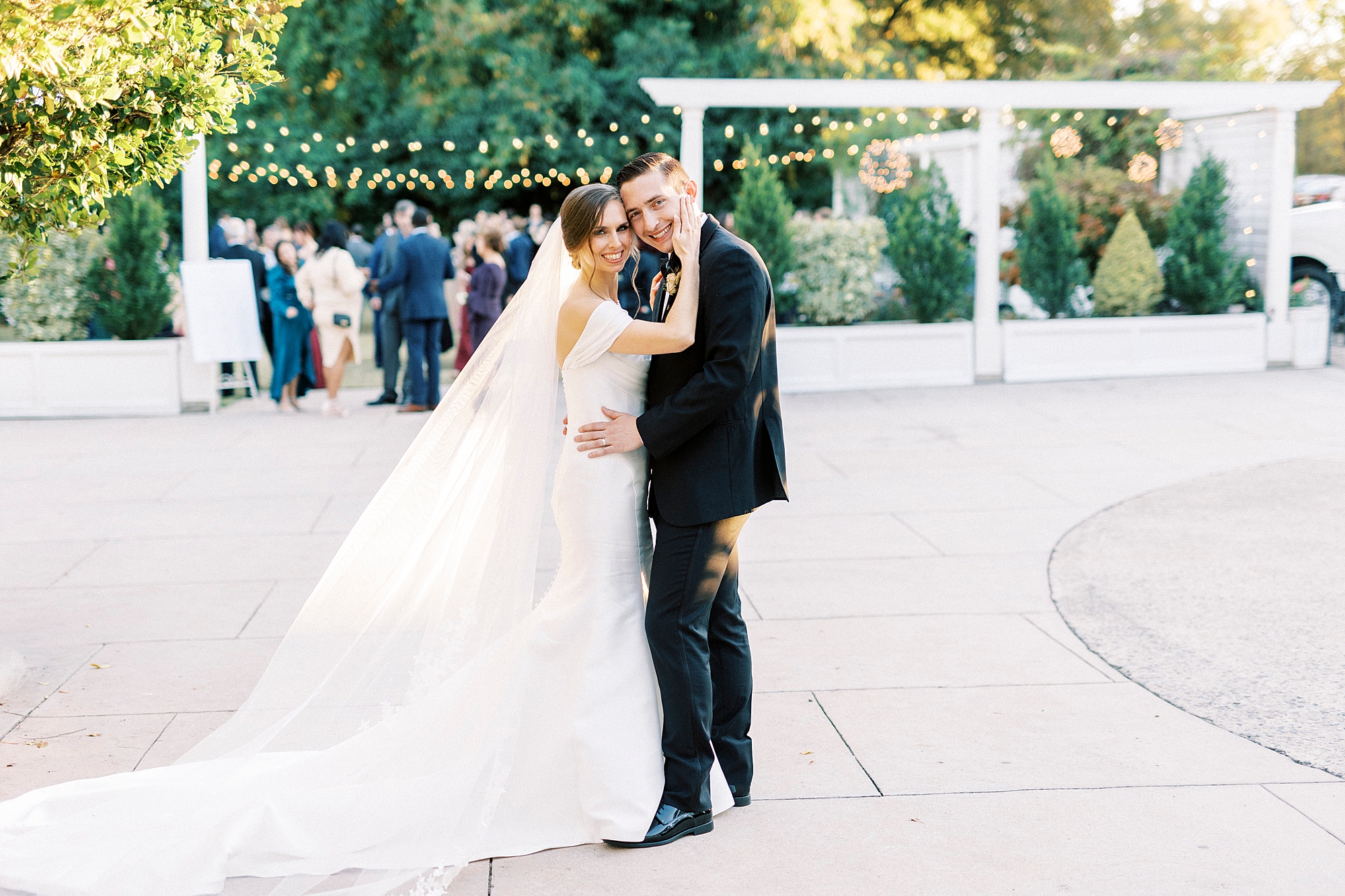 newlyweds hug on stone patio at Separk Mansion