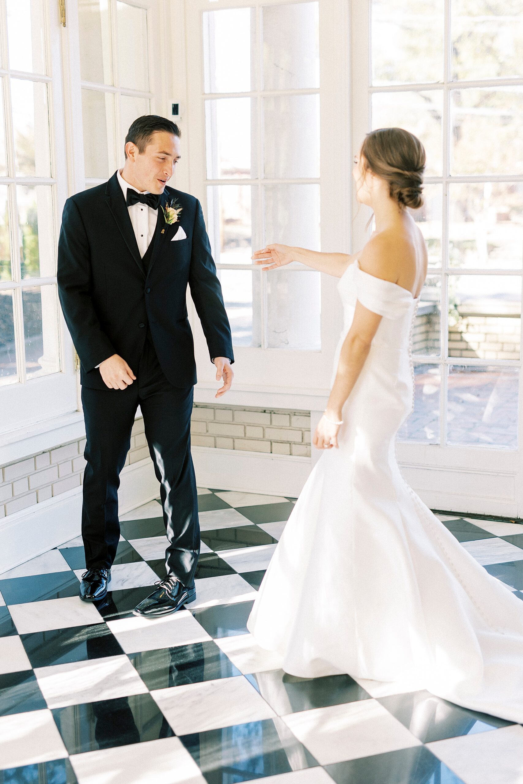 bride and groom turn to look at each other during first look at Separk Mansion