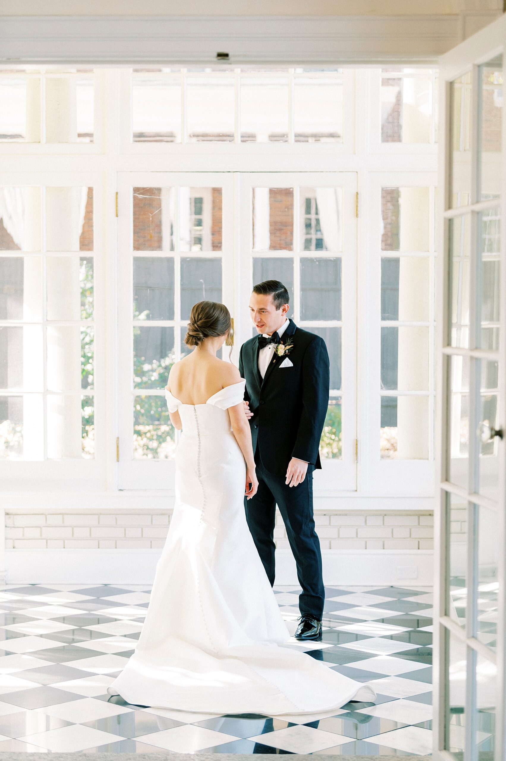 bride and groom talk during first look at Separk Mansion