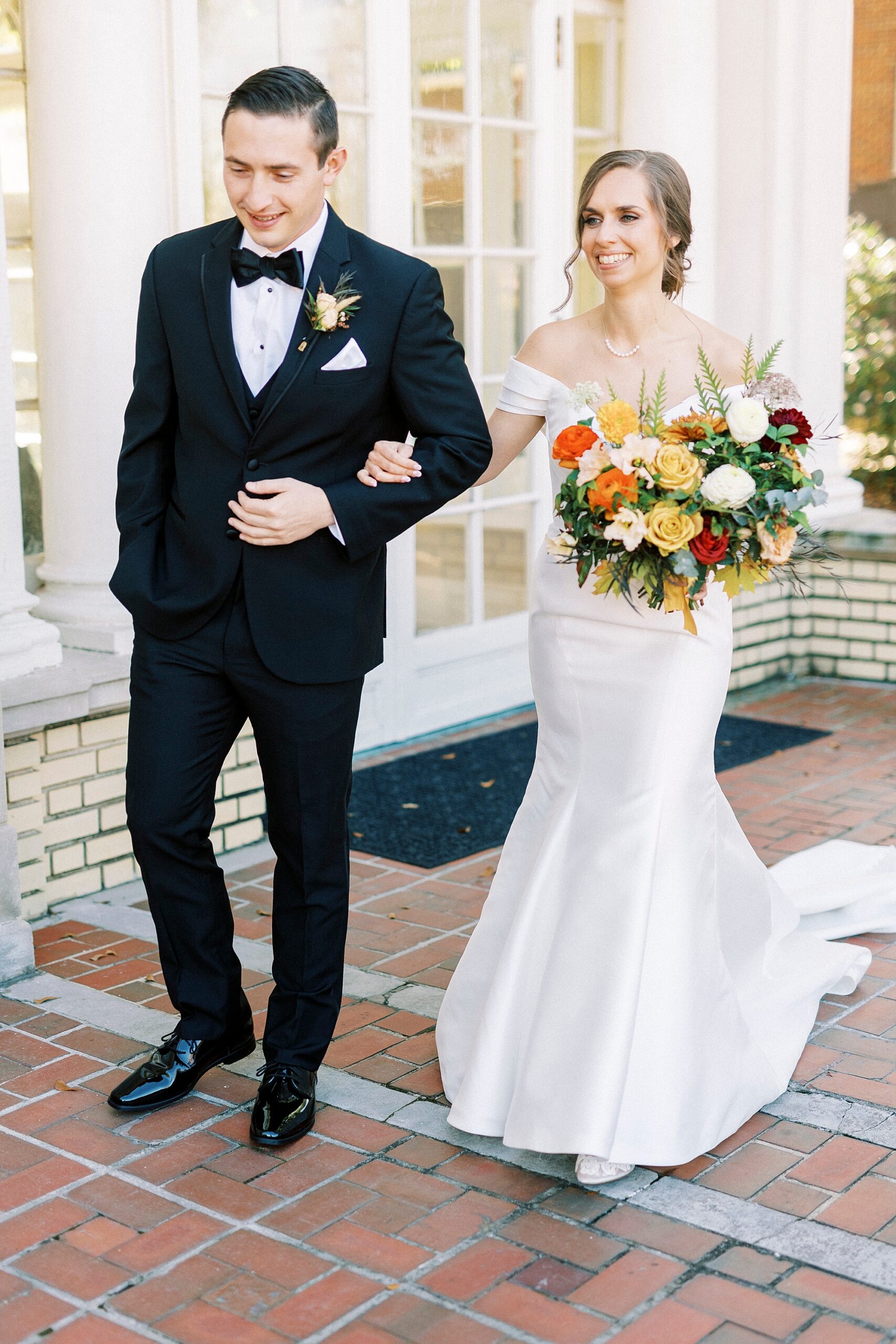 bride and groom walk on patio arm in arm at Separk Mansion