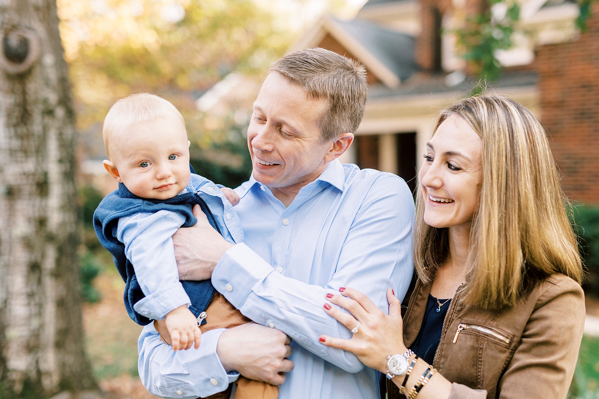 parents make son laugh during family photos outside house in Charlotte NC