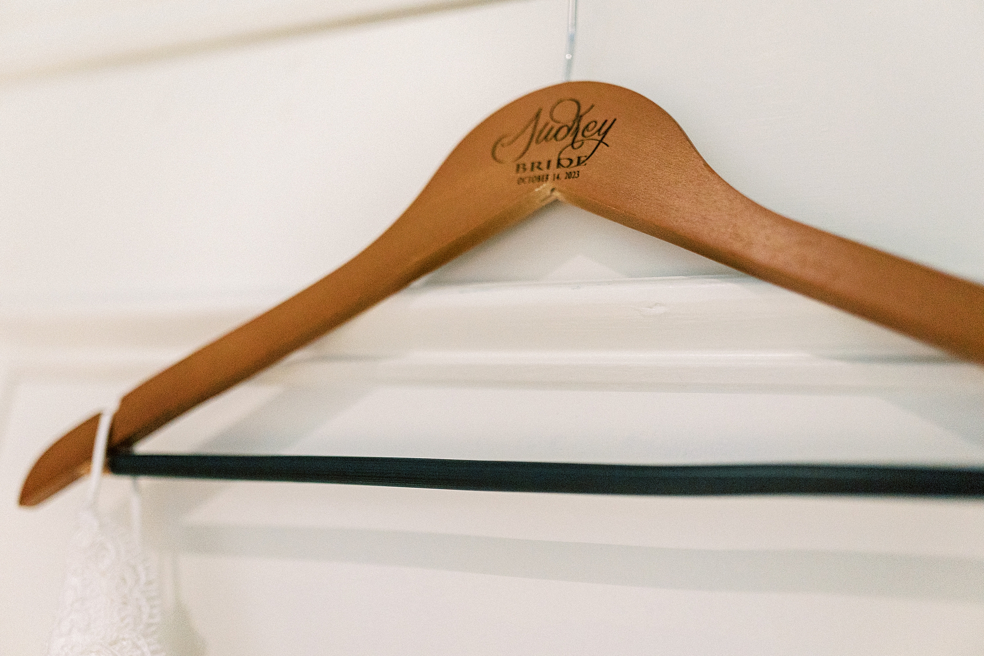 wooden hanger for bride's wedding dress inside suite