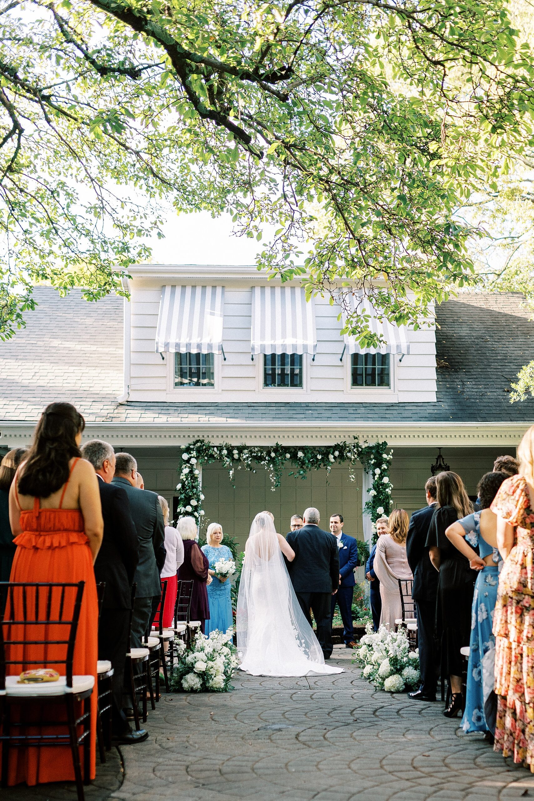 bride walks down aisle with father during NC wedding day