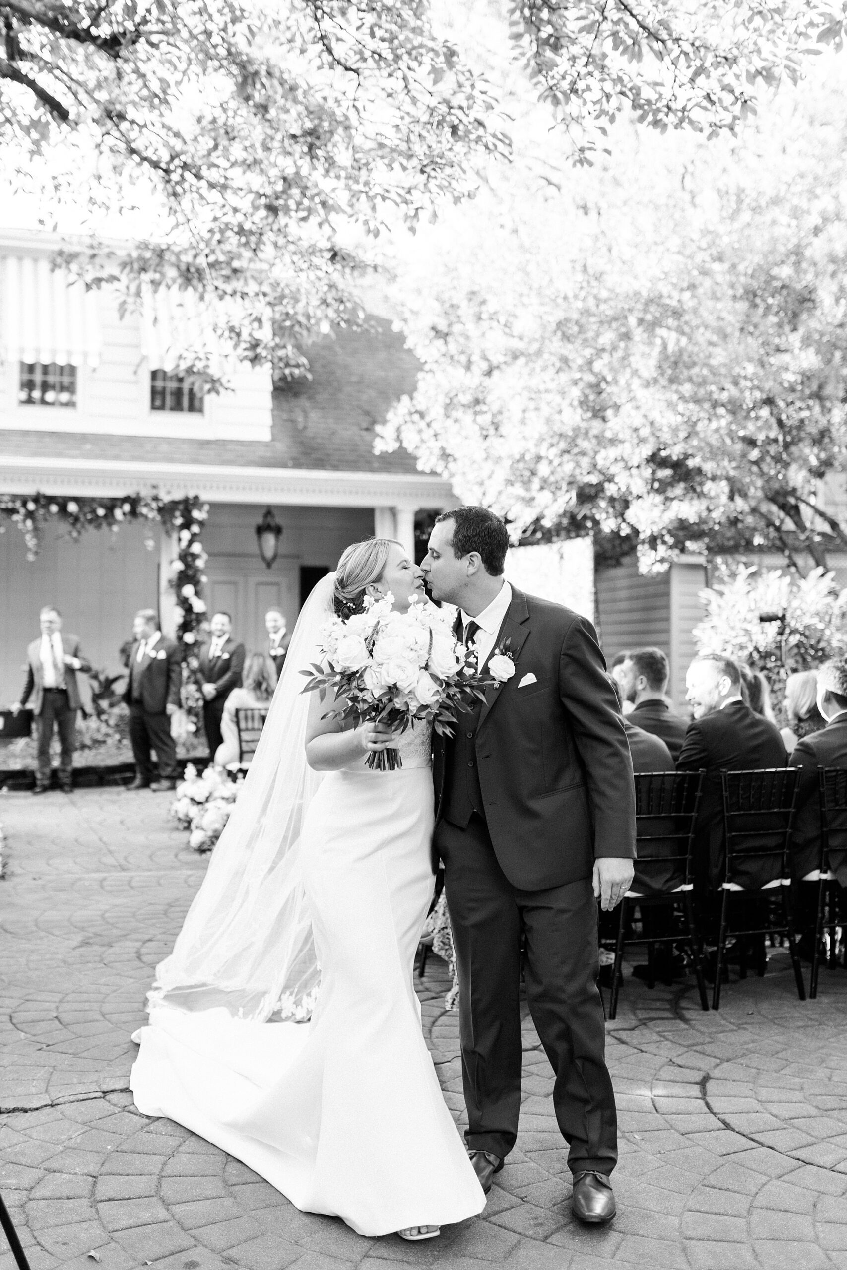 newlyweds kiss at end of aisle during NC wedding ceremony