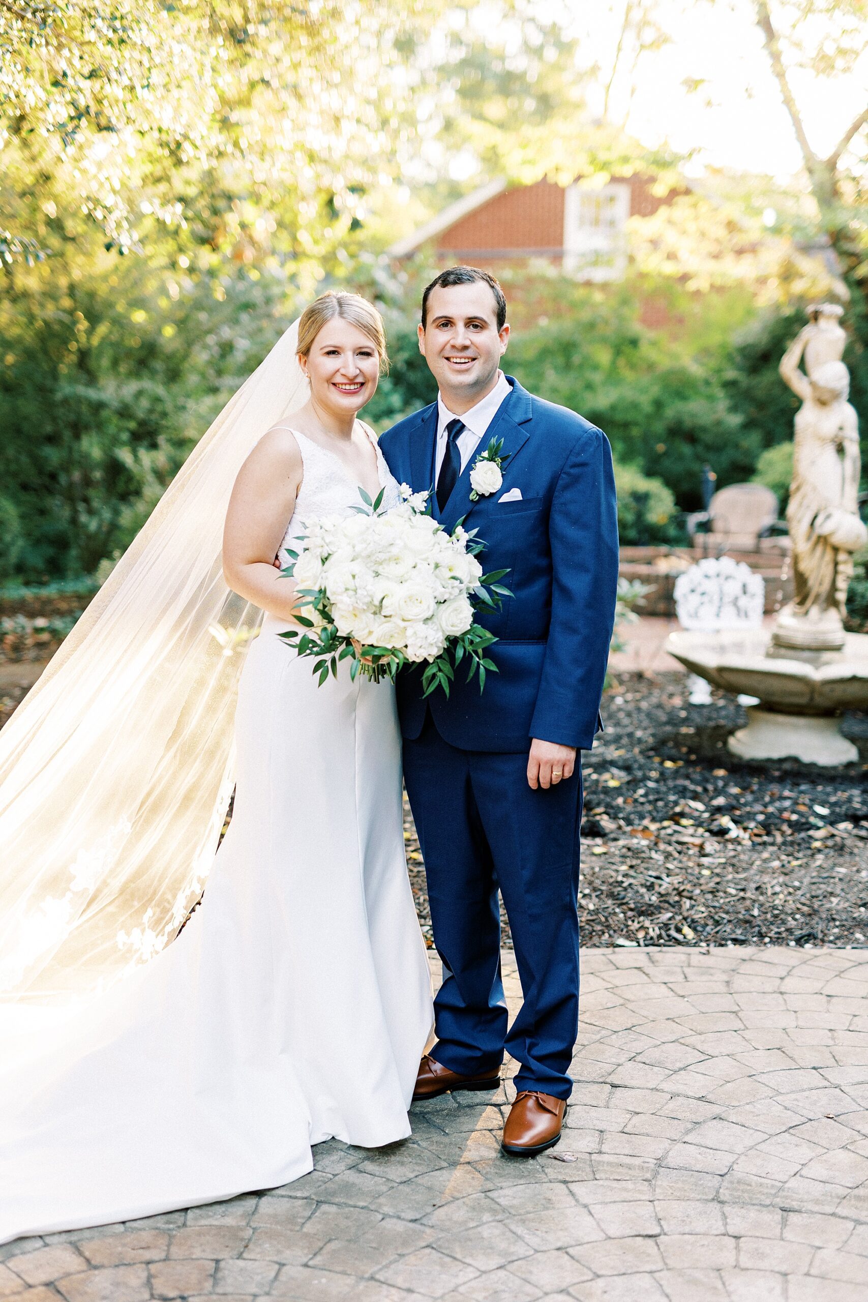 newlyweds hug on patio at the Morehead Inn