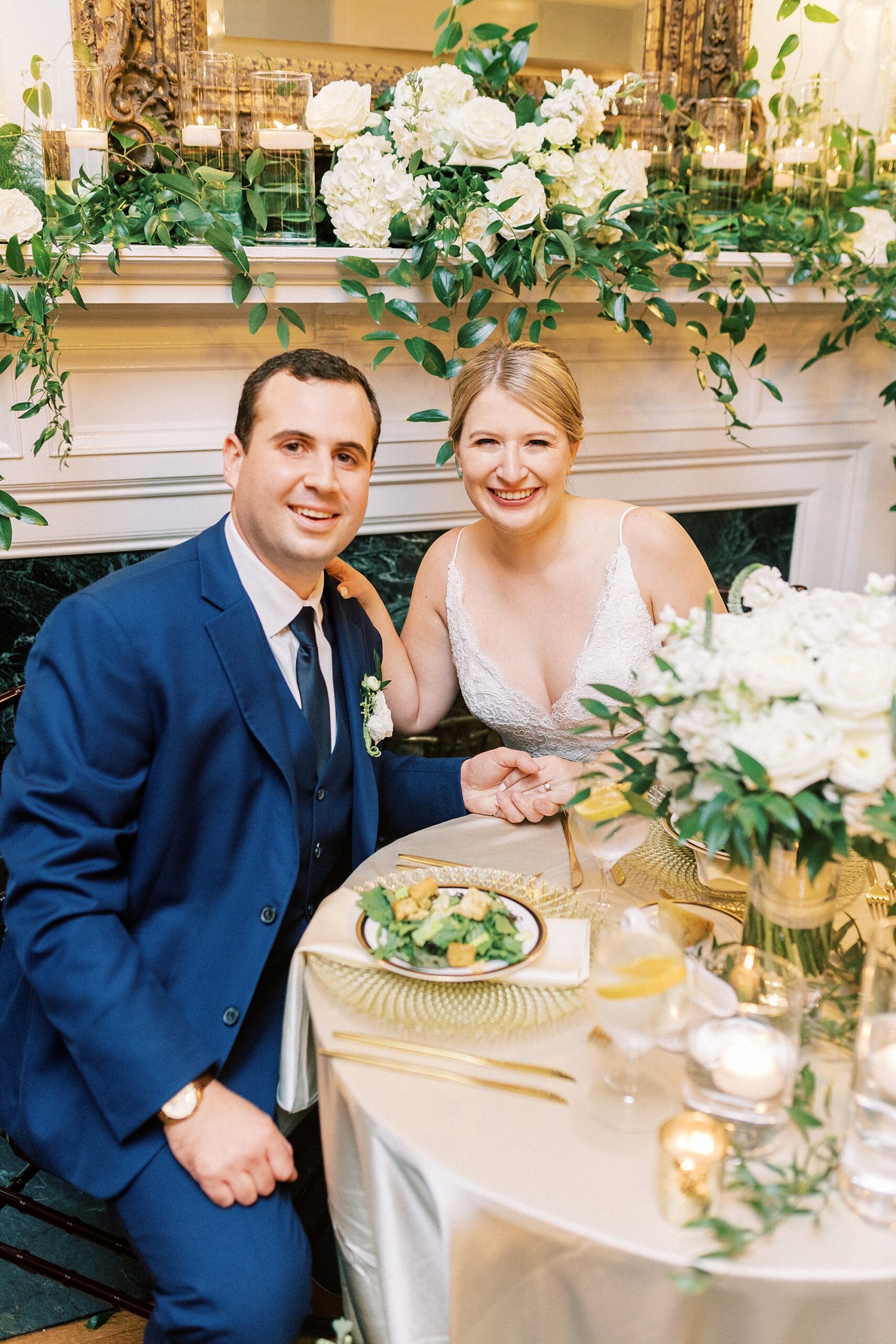 bride and groom sit at sweetheart table at the Morehead Inn