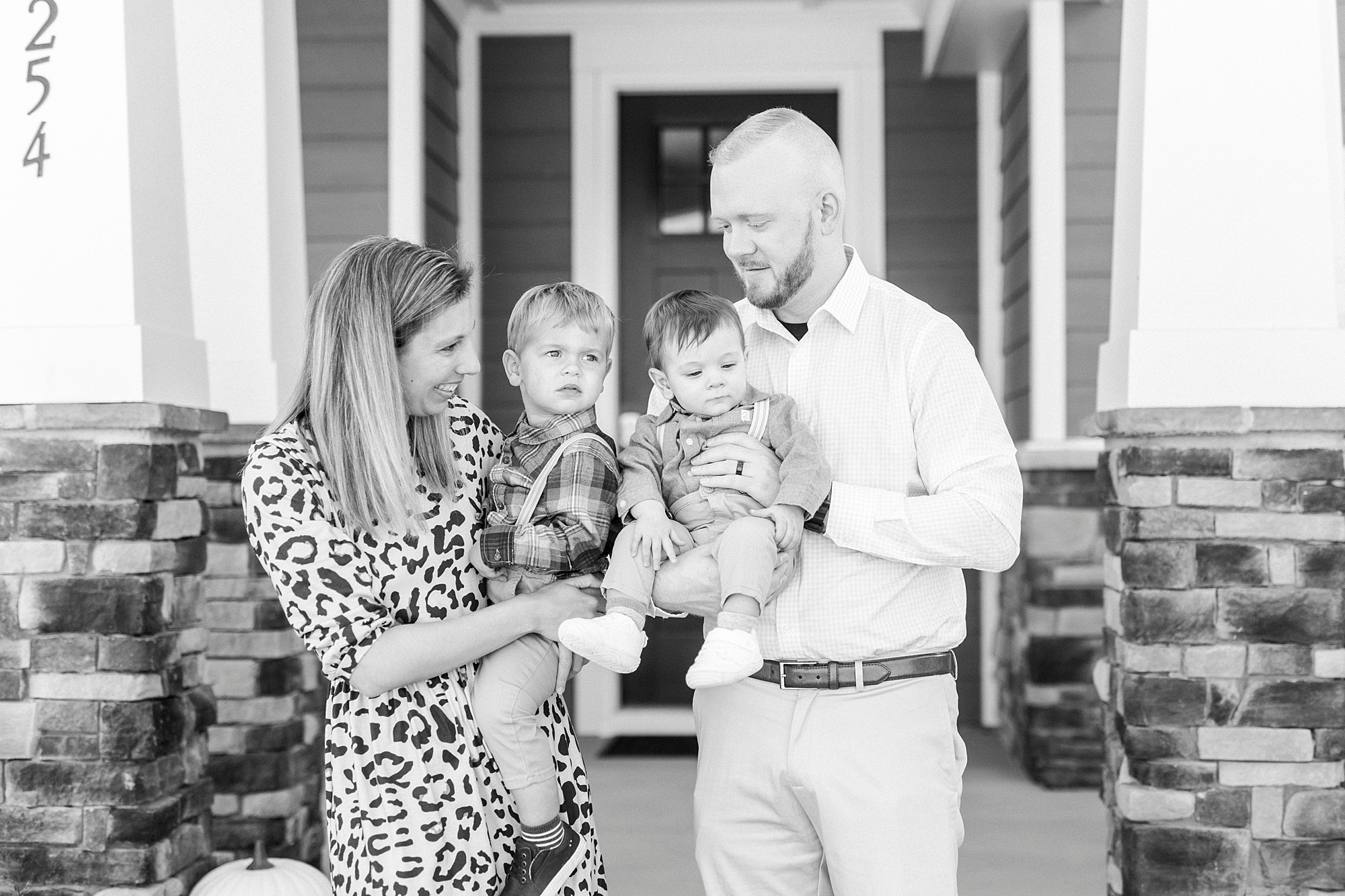 parents stand with two boys in front of home in Cramerton NC