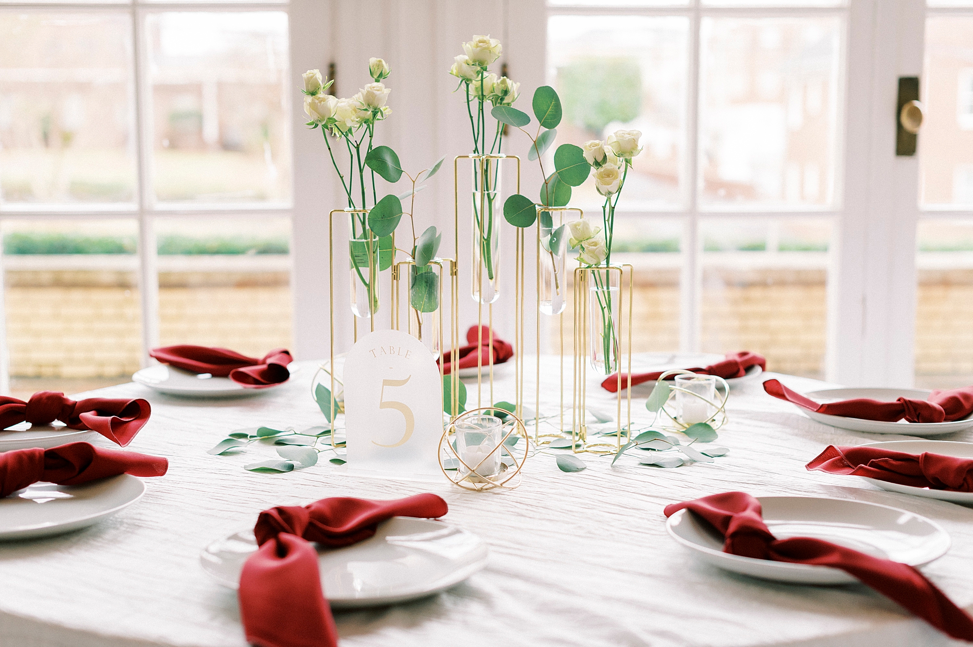classic winter wedding reception at Separk Mansion with burgundy napkins, white and green floral centerpieces 