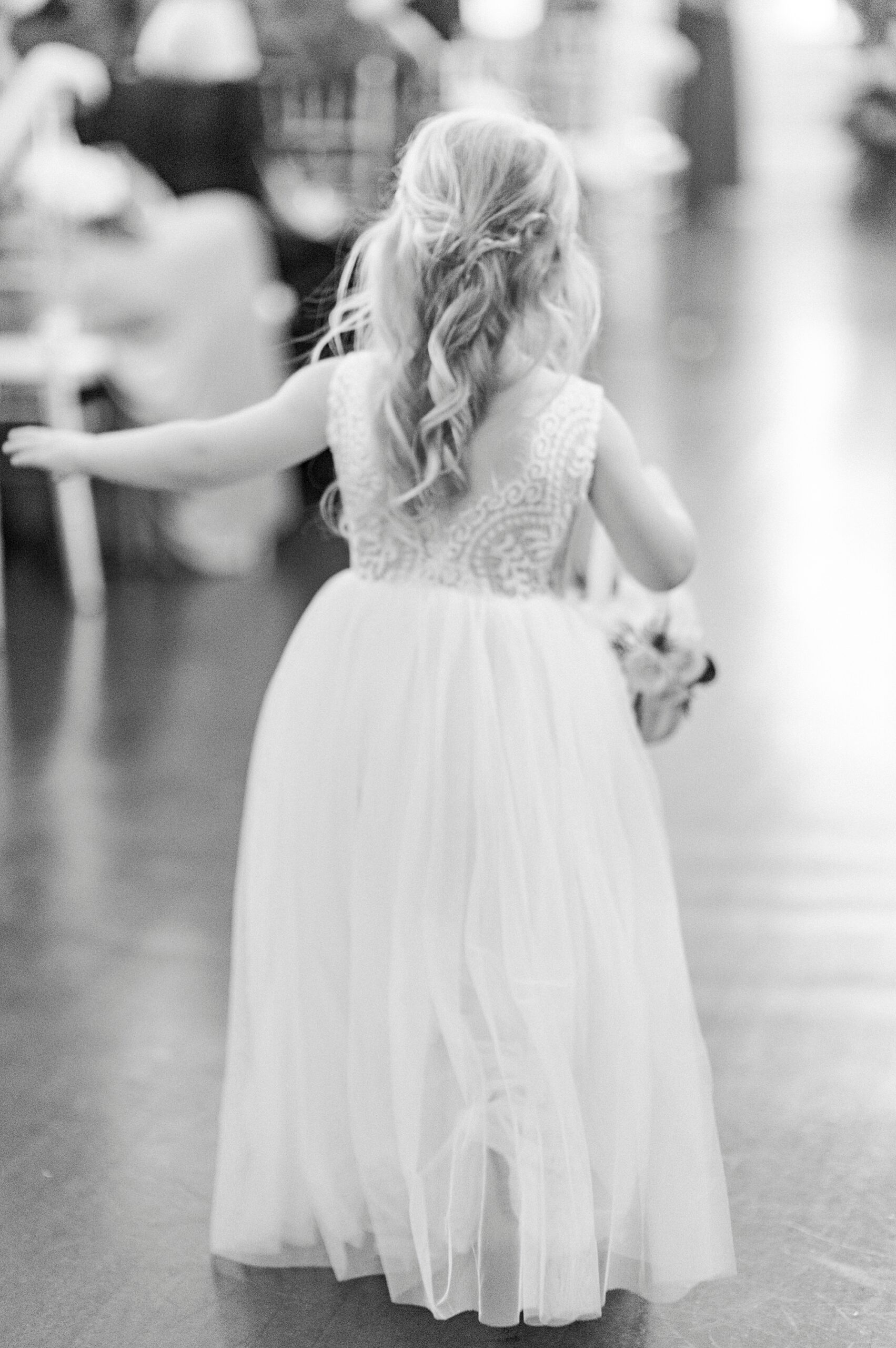 flower girl walks down the aisle with flower petals for winter wedding ceremony at Separk Mansion